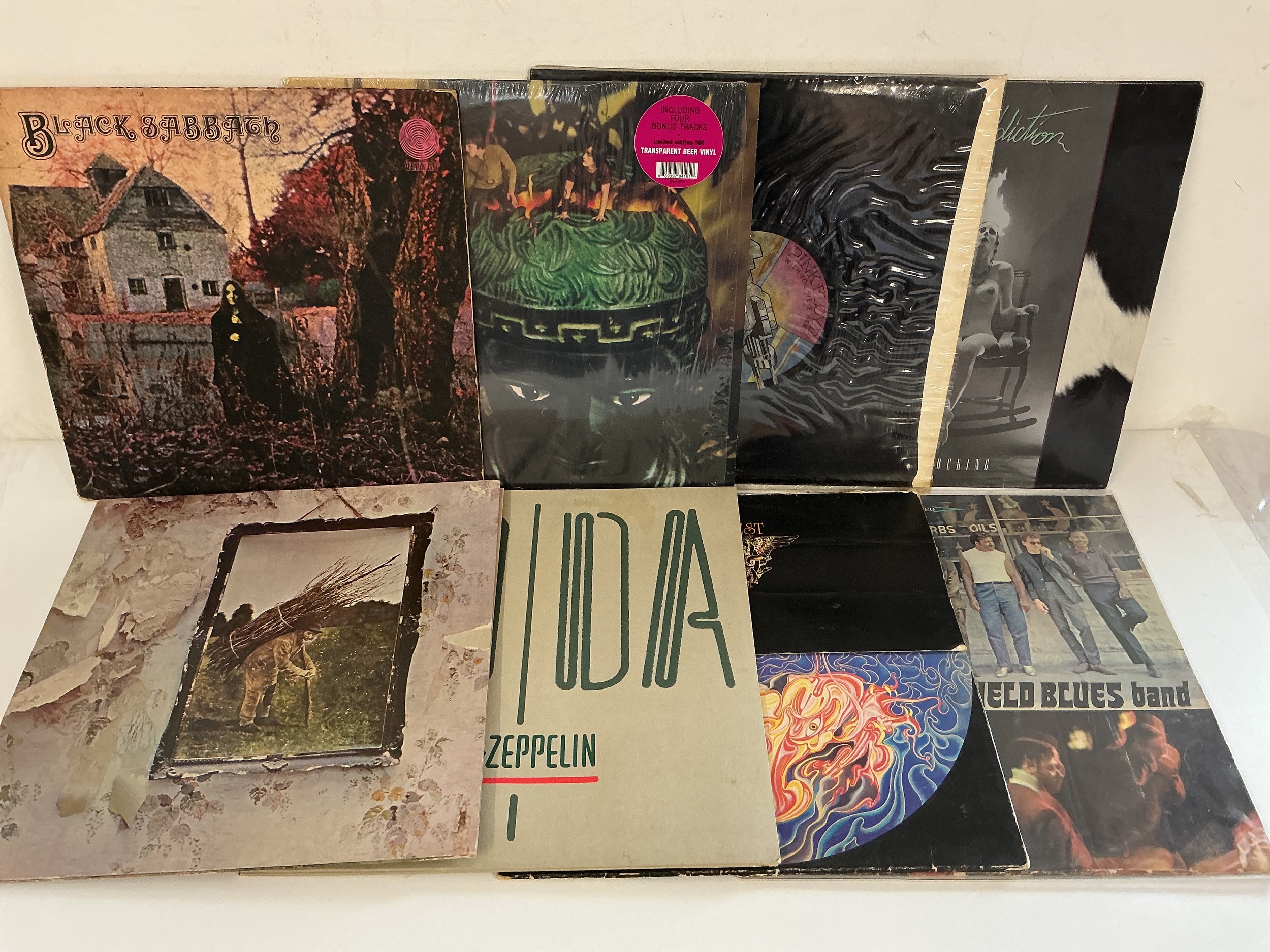 Eight rock LPs by various artists including Black Sabbath, Pink Floyd, Jane's Addiction and others.