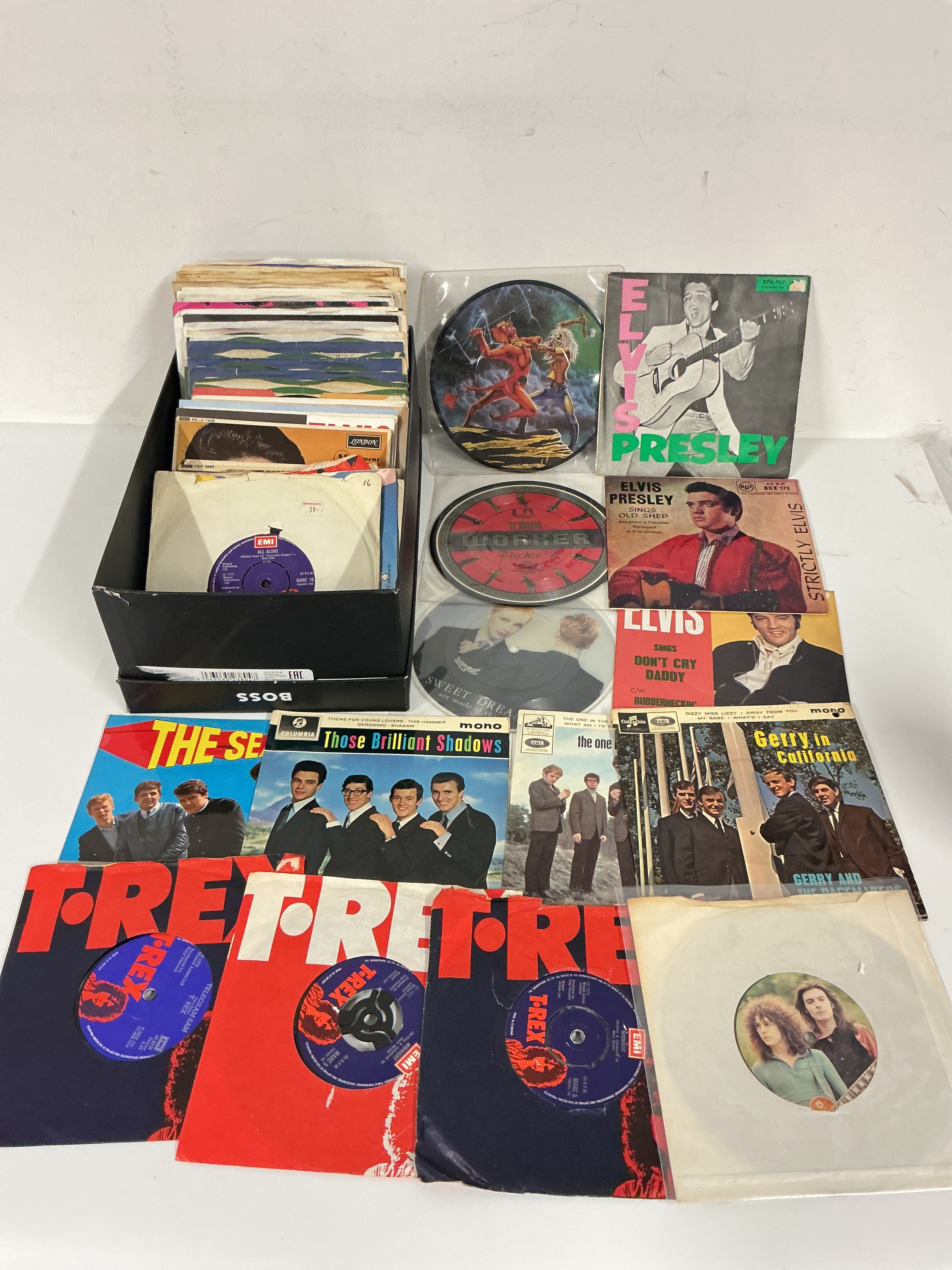 A collection of 7" singles and EPs by various artists including Elvis Presley, T Rex, Iron Maiden and others. Includes picture discs.