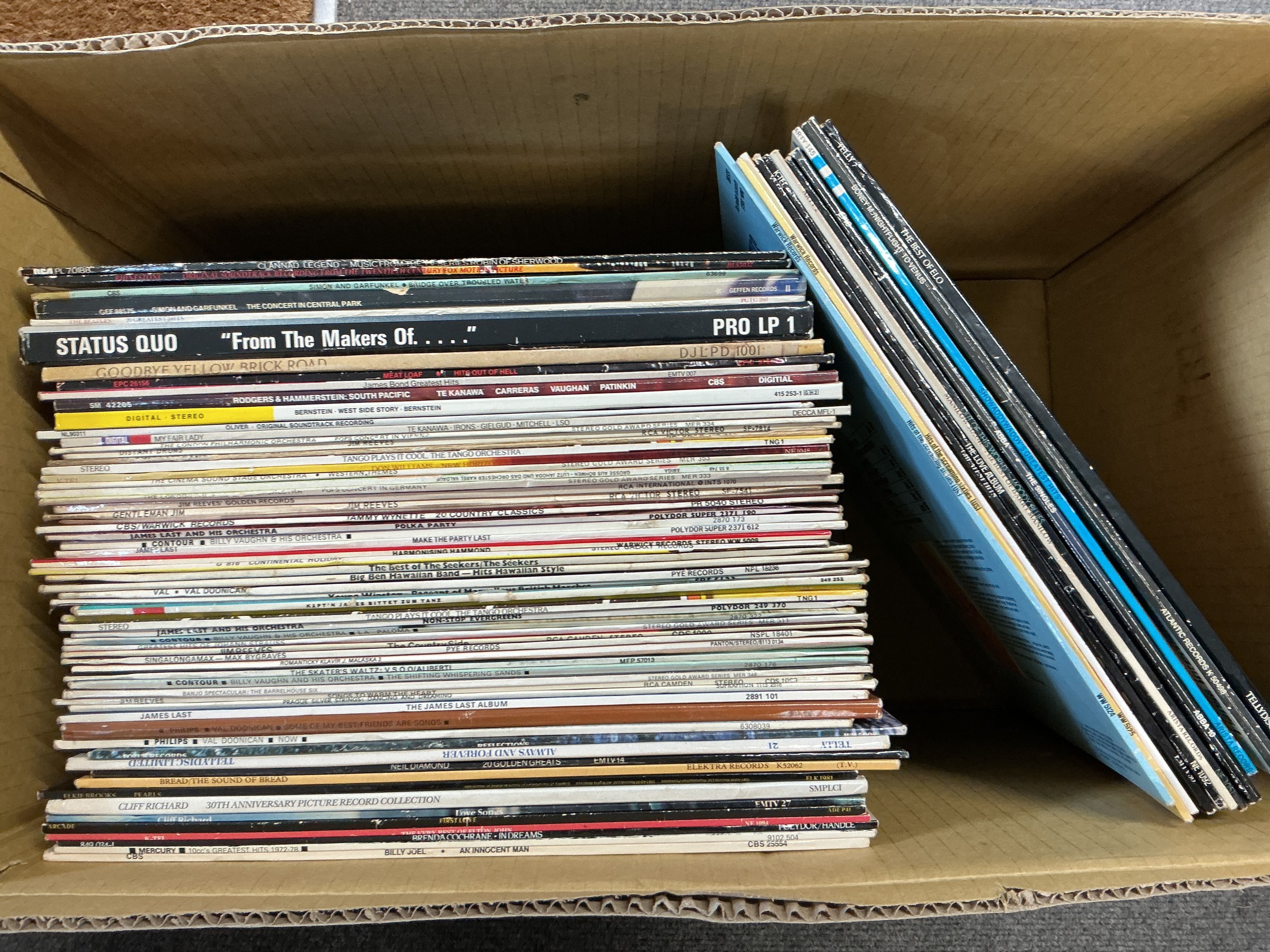 A collection of LPs by various artists including Elton John, ELO, Simon & Garfunkel and others.