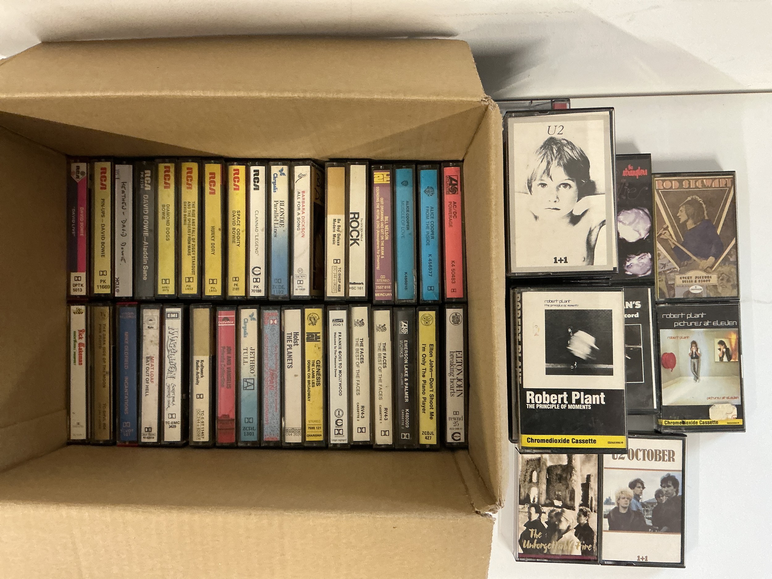A collection of audio cassettes by various artists including Kraftwerk, Pink Floyd, David Bowie and others.
