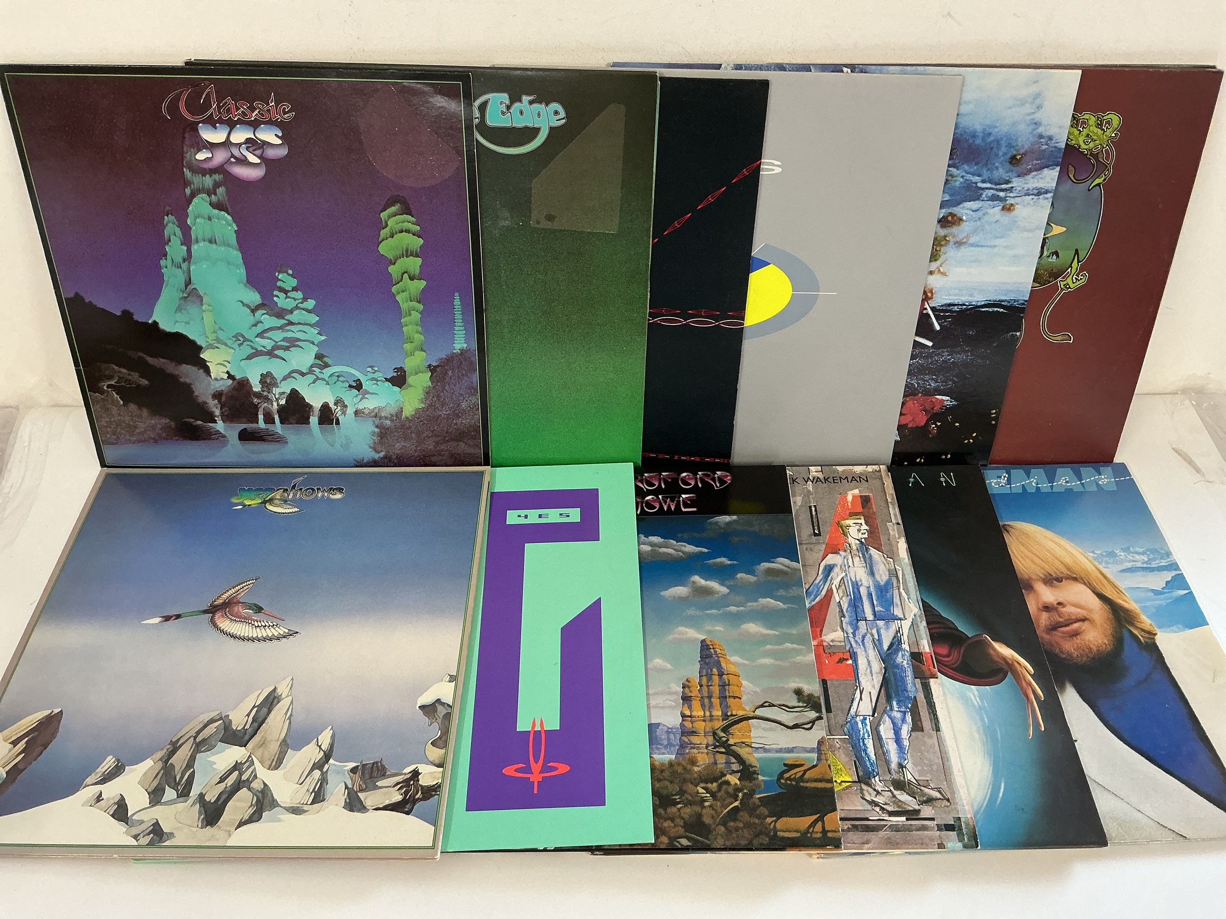 Eleven Yes and related LPs and a 12" single comprising Close To The Edge, Yessongs, No Earthly connection and others.