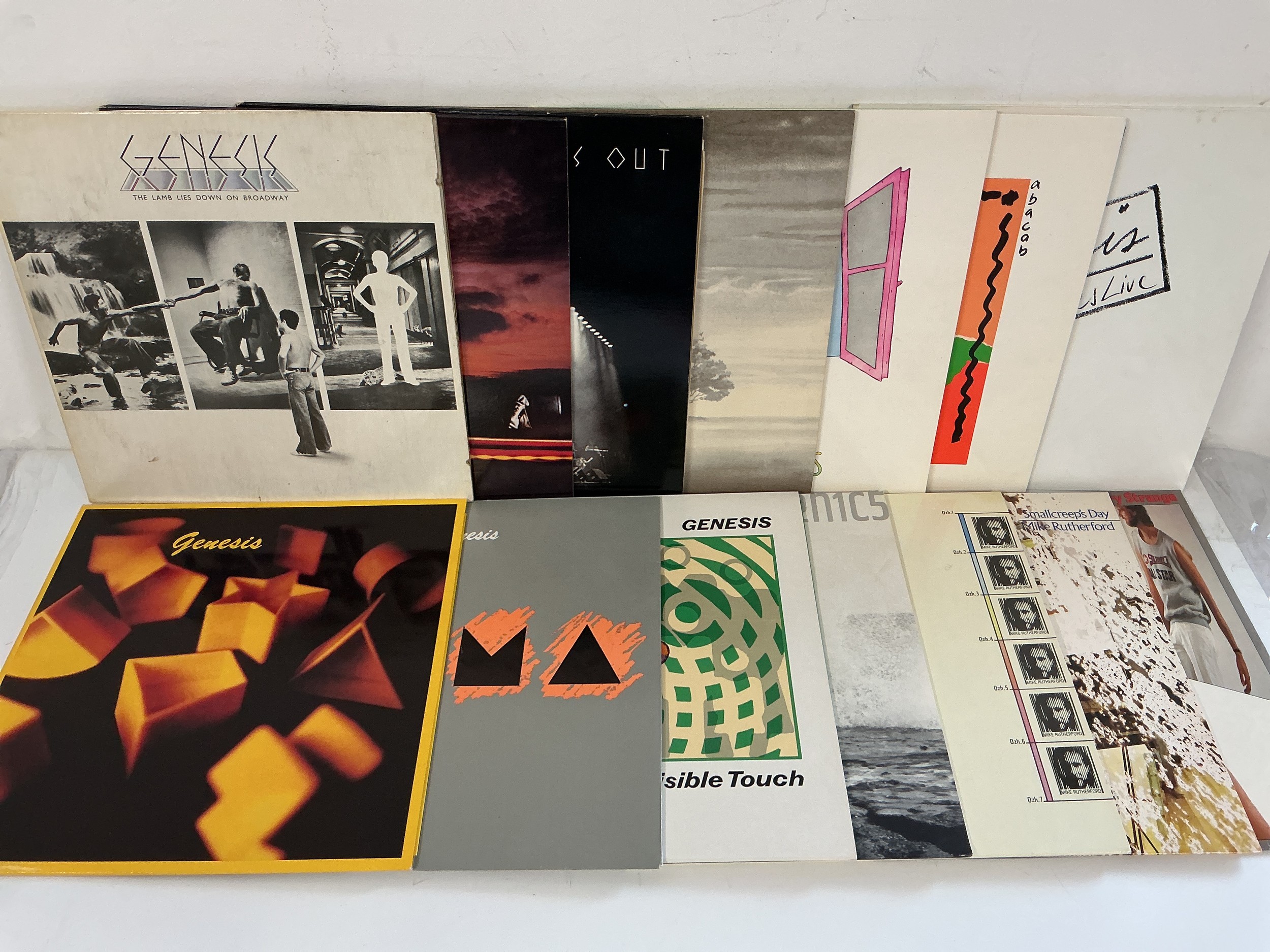 Ten Genesis and related LPs and 12" singles comprising The Lamb Lies Down On Broadway, Three Sides Live, Acting Very Strange and others.