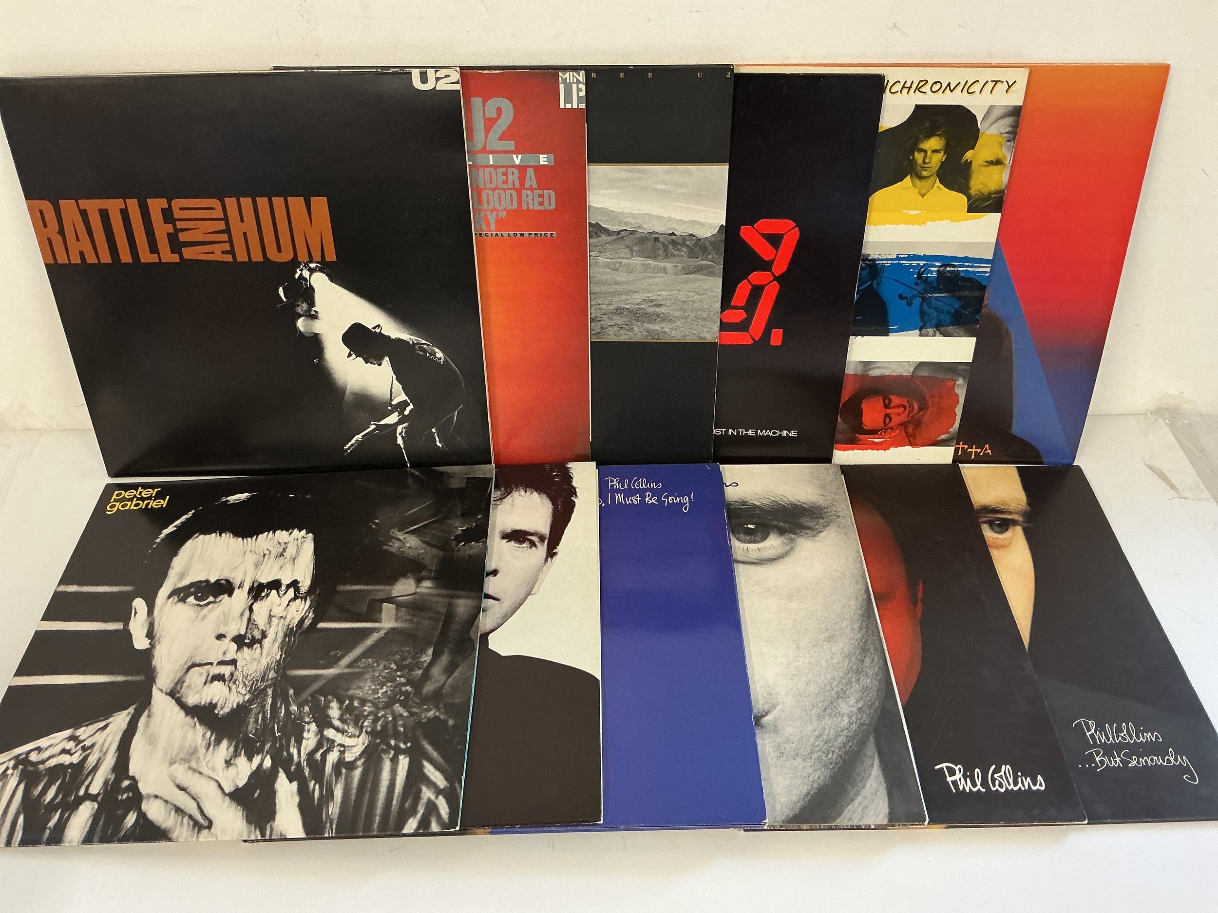 Twelve LPs by various artists comprising Peter Gabriel, U2, Phil Collins and The Police.