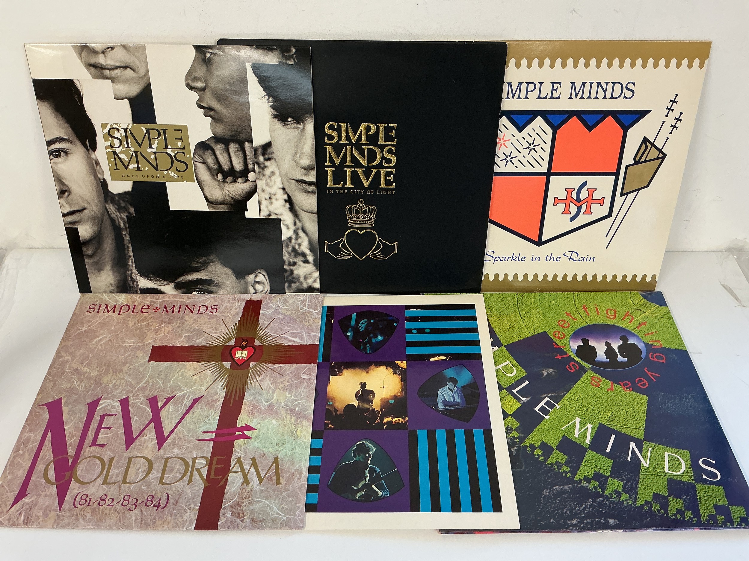 Five Simple Minds LPs and a 12" single comprising Once Upon A Time, Sparkle in The Rain and others.