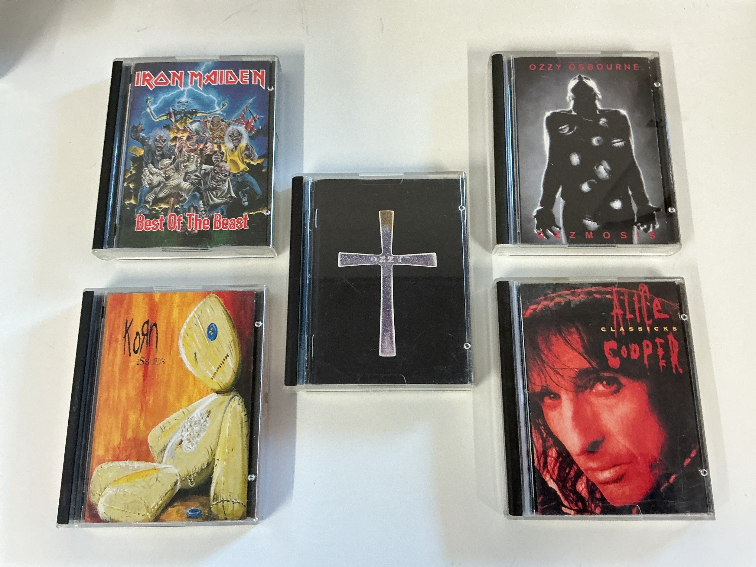 Five heavy rock minidiscs by various artists comprising Iron Maiden, Alice Cooper, Ozzy Osbourne and Korn.