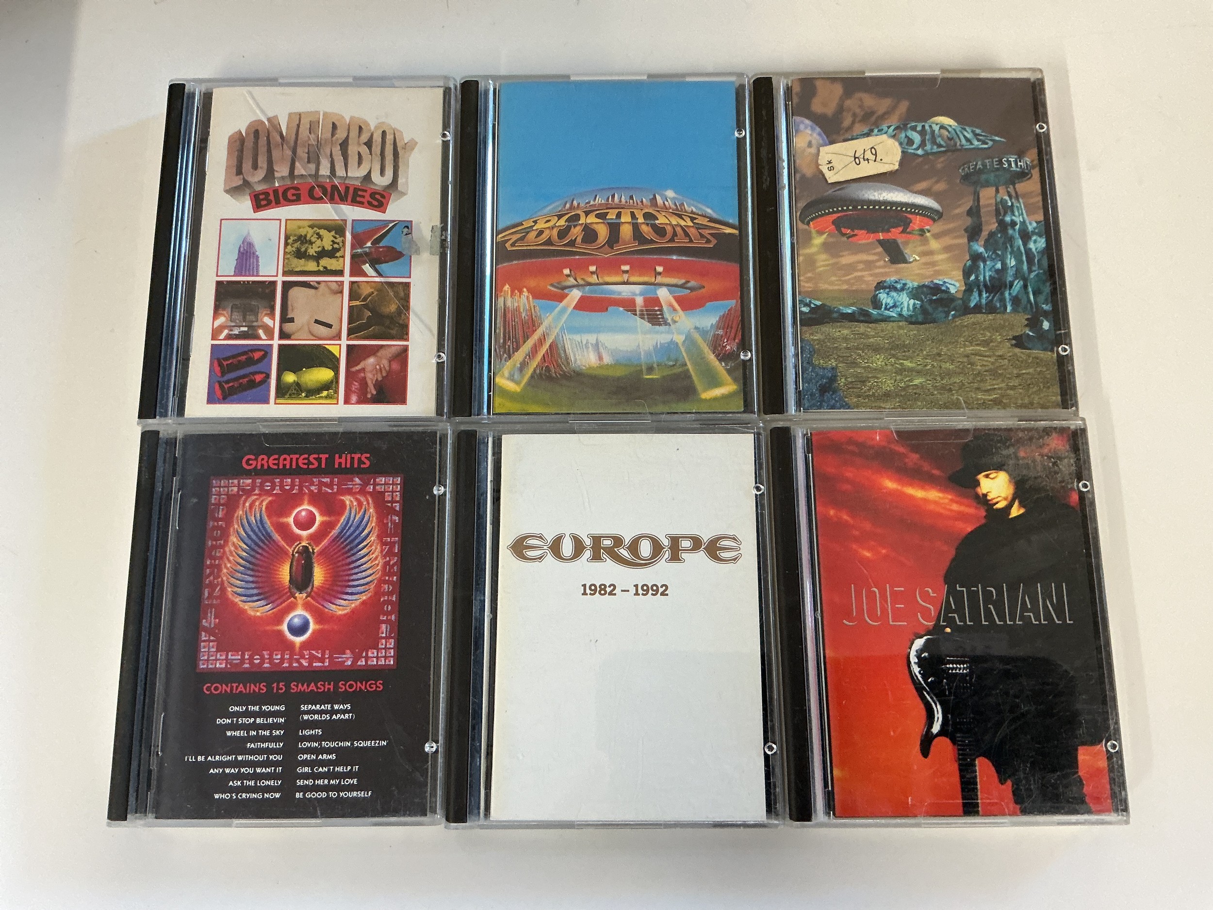 Six minidiscs by various artists including Boston, Europe, Journey, Loverboy and Joe Satriani.