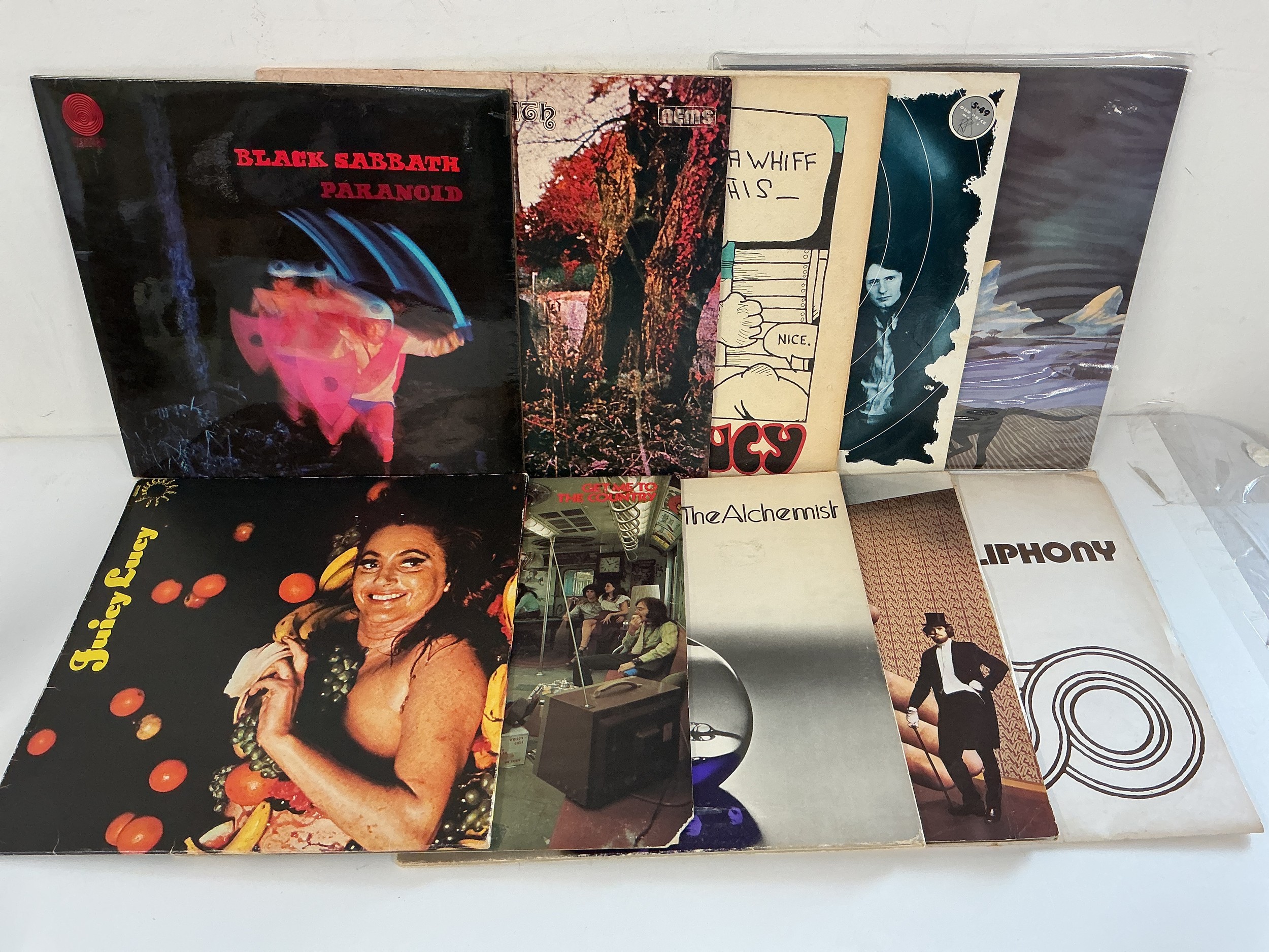 Ten prog and hard rock LPs by various artists including an early UK pressing of Paranoid by Black Sabbath, Juicy Lucy, Caravan and others.