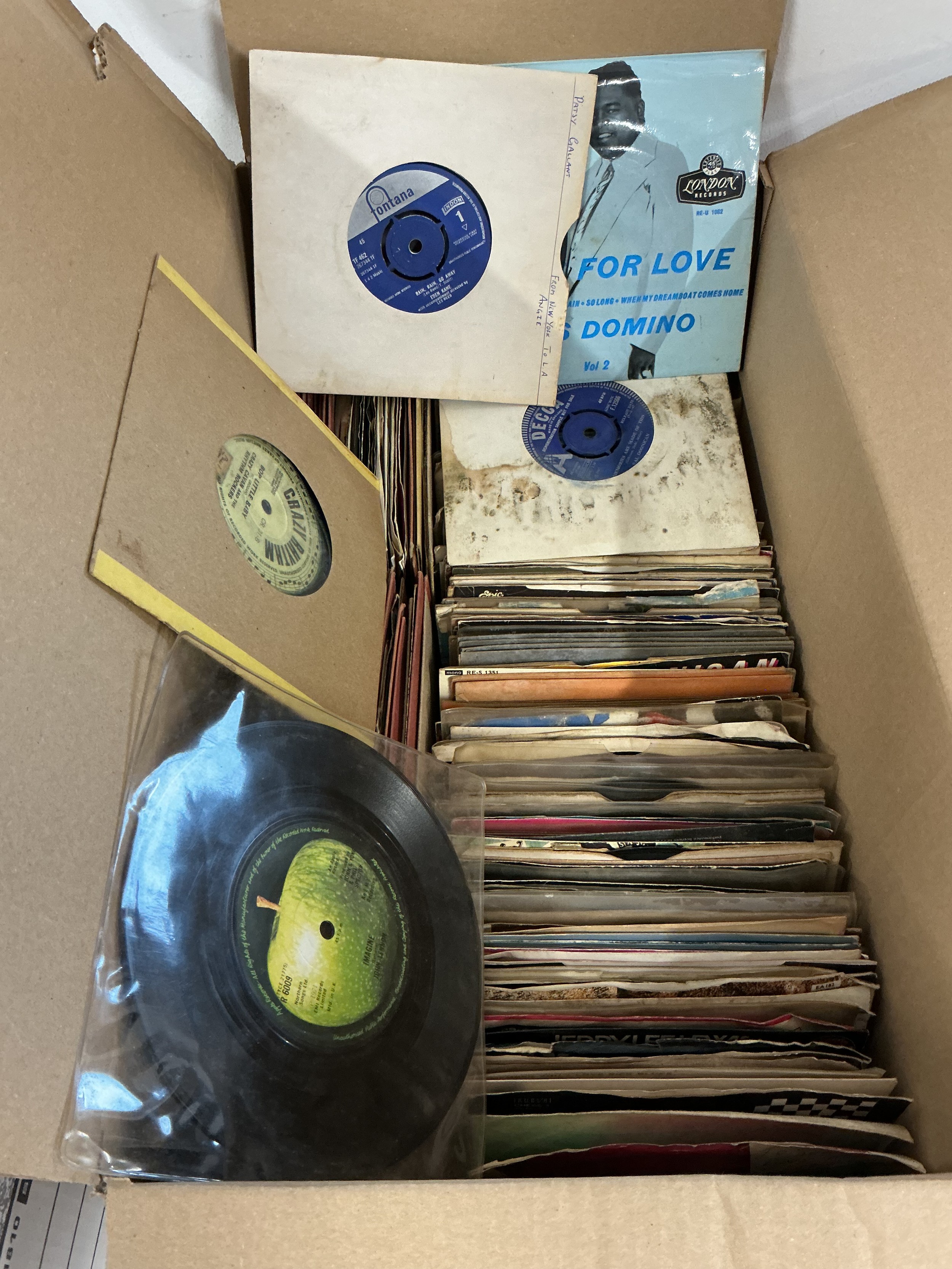Three boxes of 7" singles and EPs by various artists. Includes rock n roll, 60s and later rock and pop. Some have mildew/water damage.