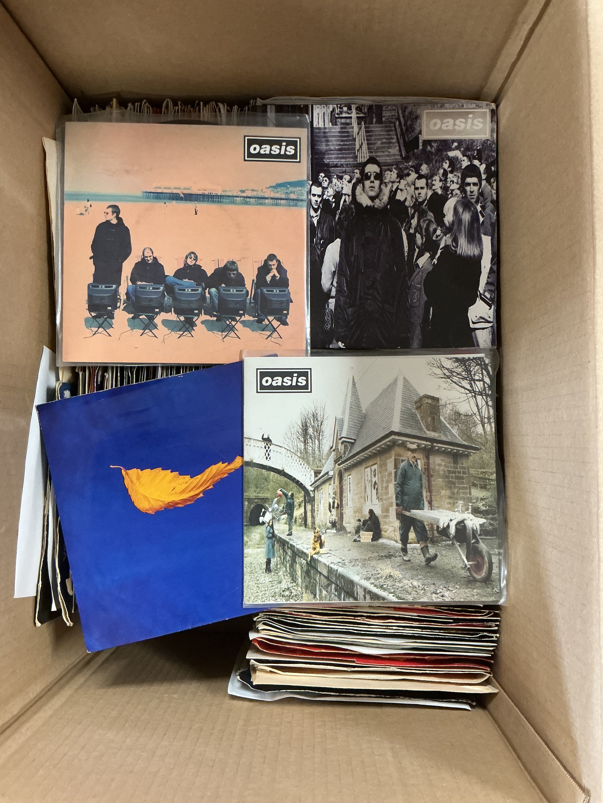Two boxes of 7" singles by various artists including Oasis, The KLF, New Order, Adam & The Ants and many more.