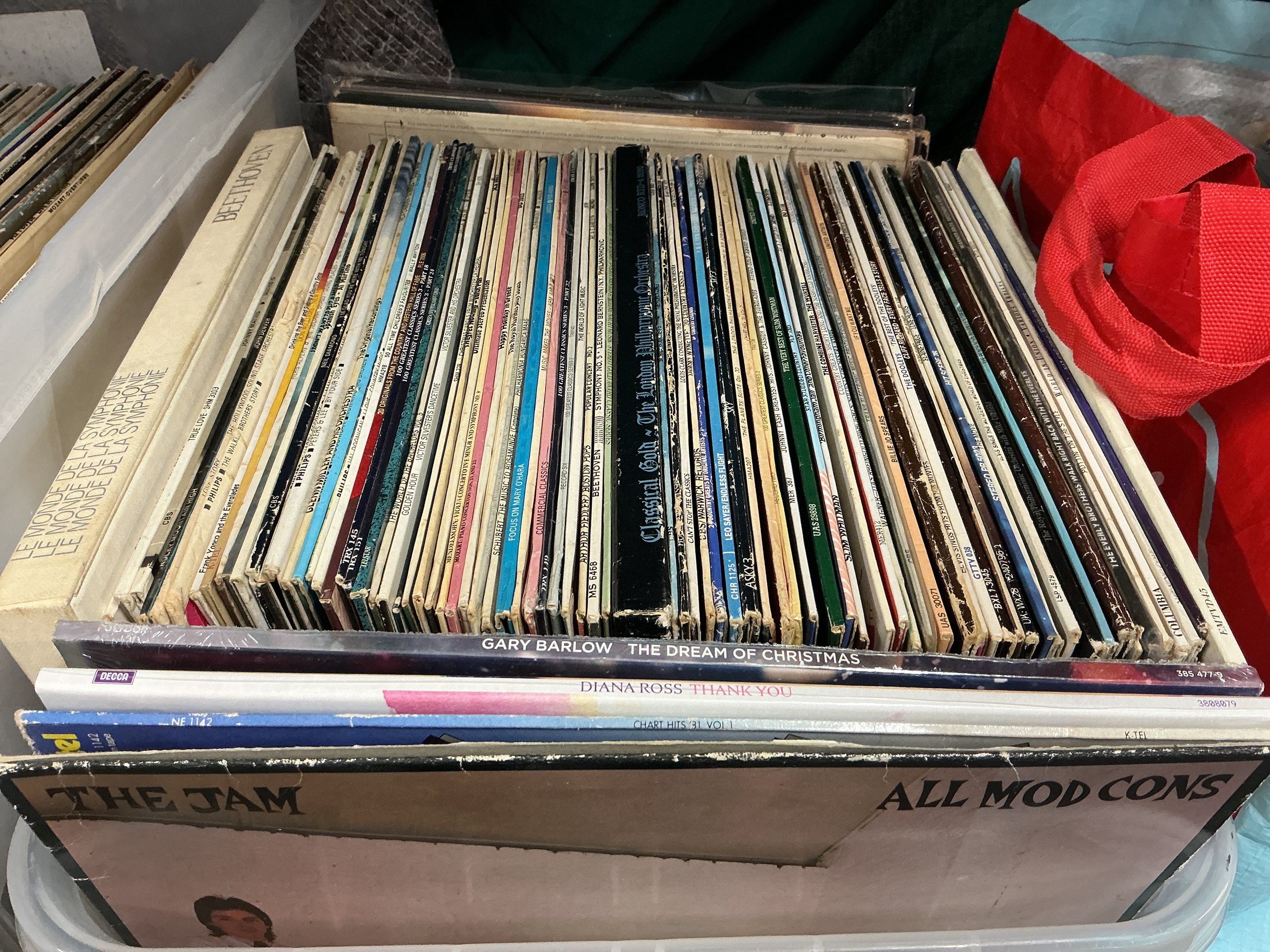 Three boxes and a bag of LPs by various artists including The Beatles, Kate Bush, The Jam, Elvis Presley and many more.