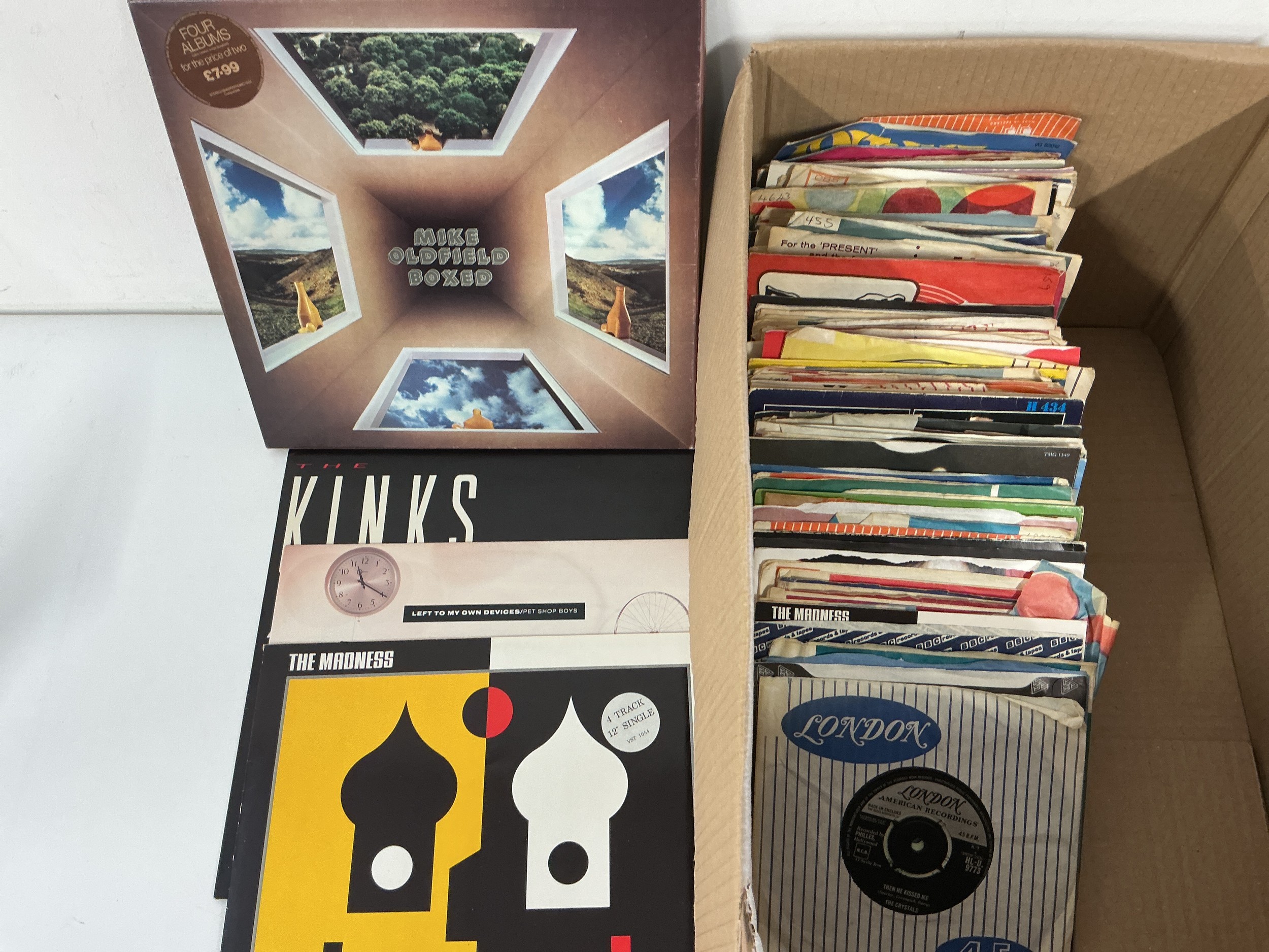A box of 7" and 12" singles by various artists plus a Mike Oldfield 4LP box set.