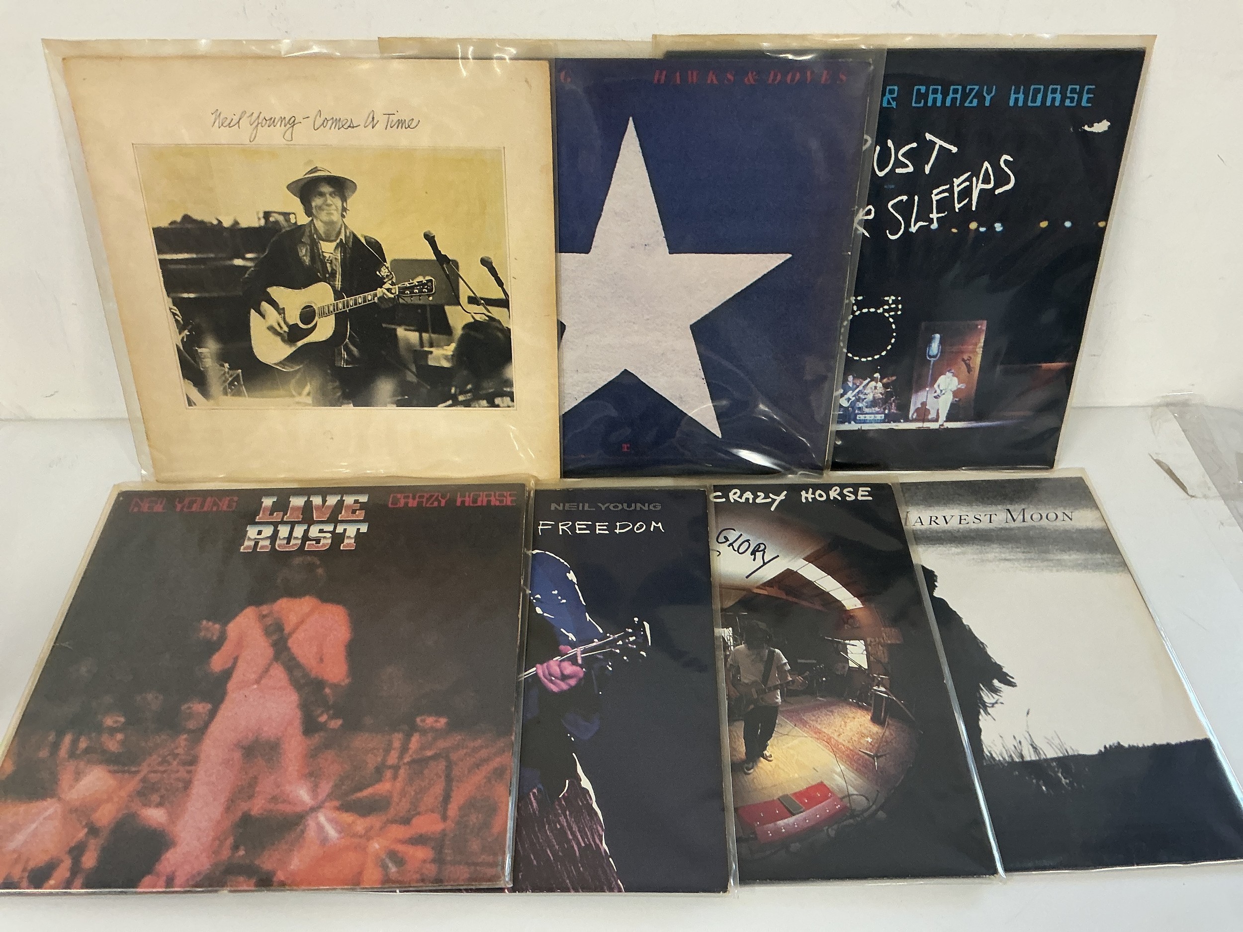 Seven Neil Young LPs comprising Live Rust, Comes A Time, Ragged Glory and others. Please note there is a discernible odour of old cigarette smoke to this lot