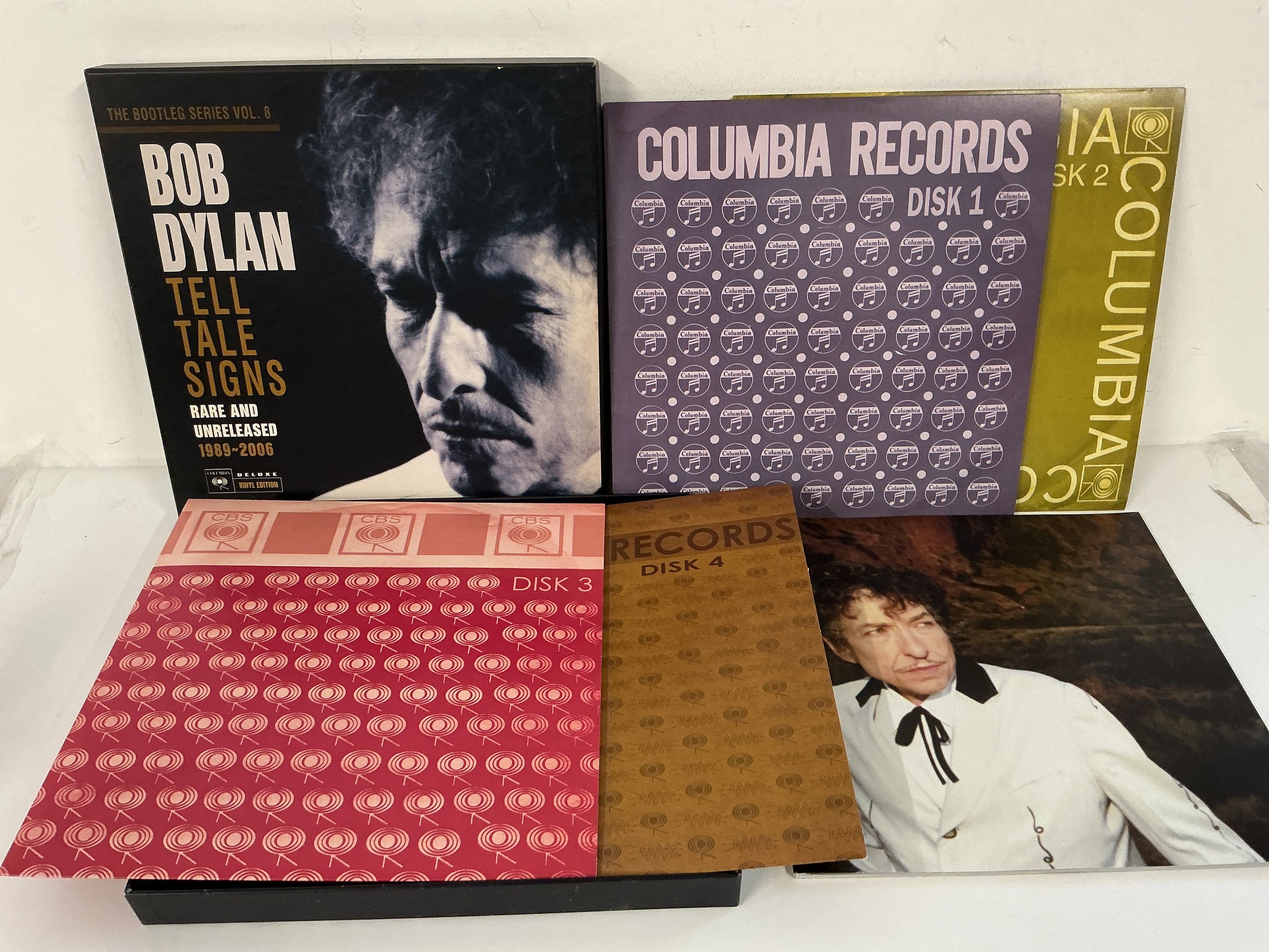 A Bob Dylan - Tell Tale Signs 4LP box set. Please note there is a discernible odour of old cigarette smoke to this lot
