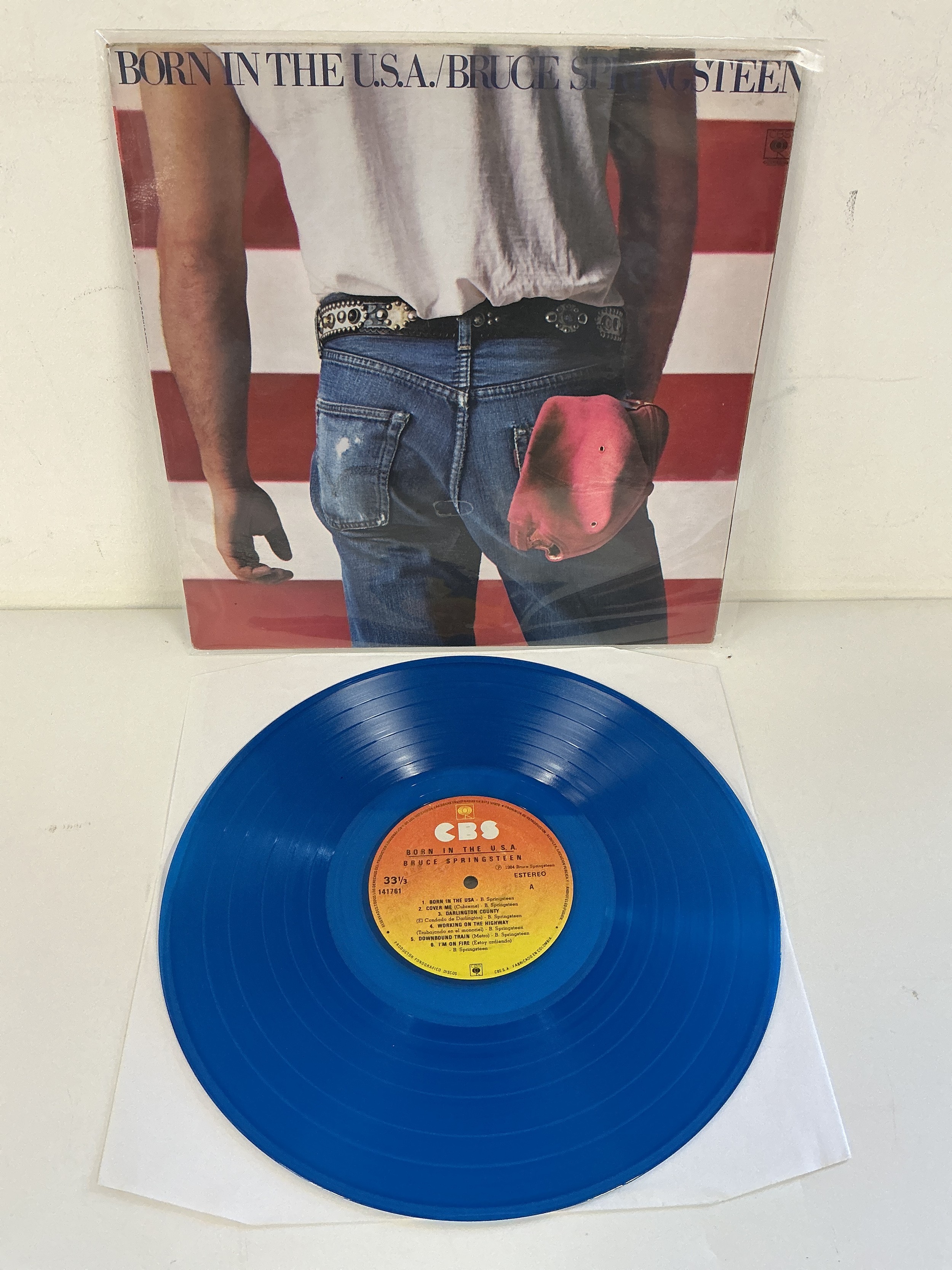 A rare Colombian pressing of the Bruce Springsteen LP Born in The USA on blue vinyl. EX/EX.