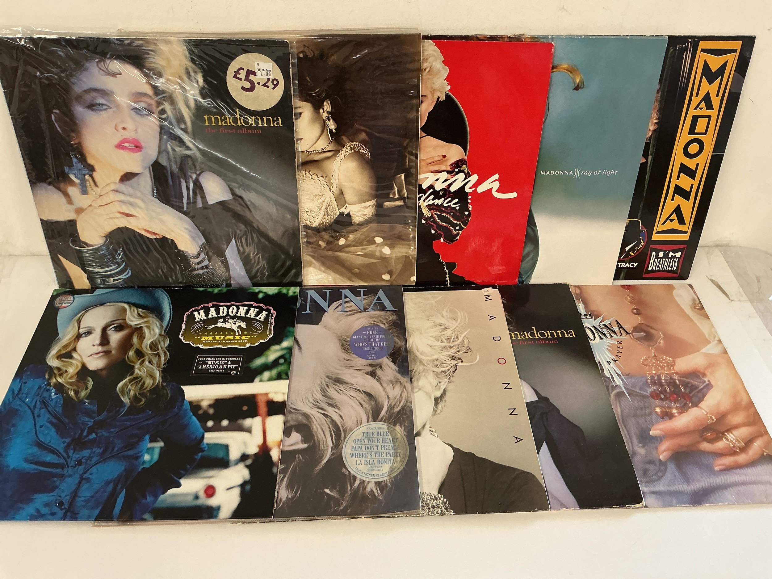 Two bags containing twenty Madonna LPs and 12" singles comprising The First Album, Ray Of Light, Like A Prayer and others.