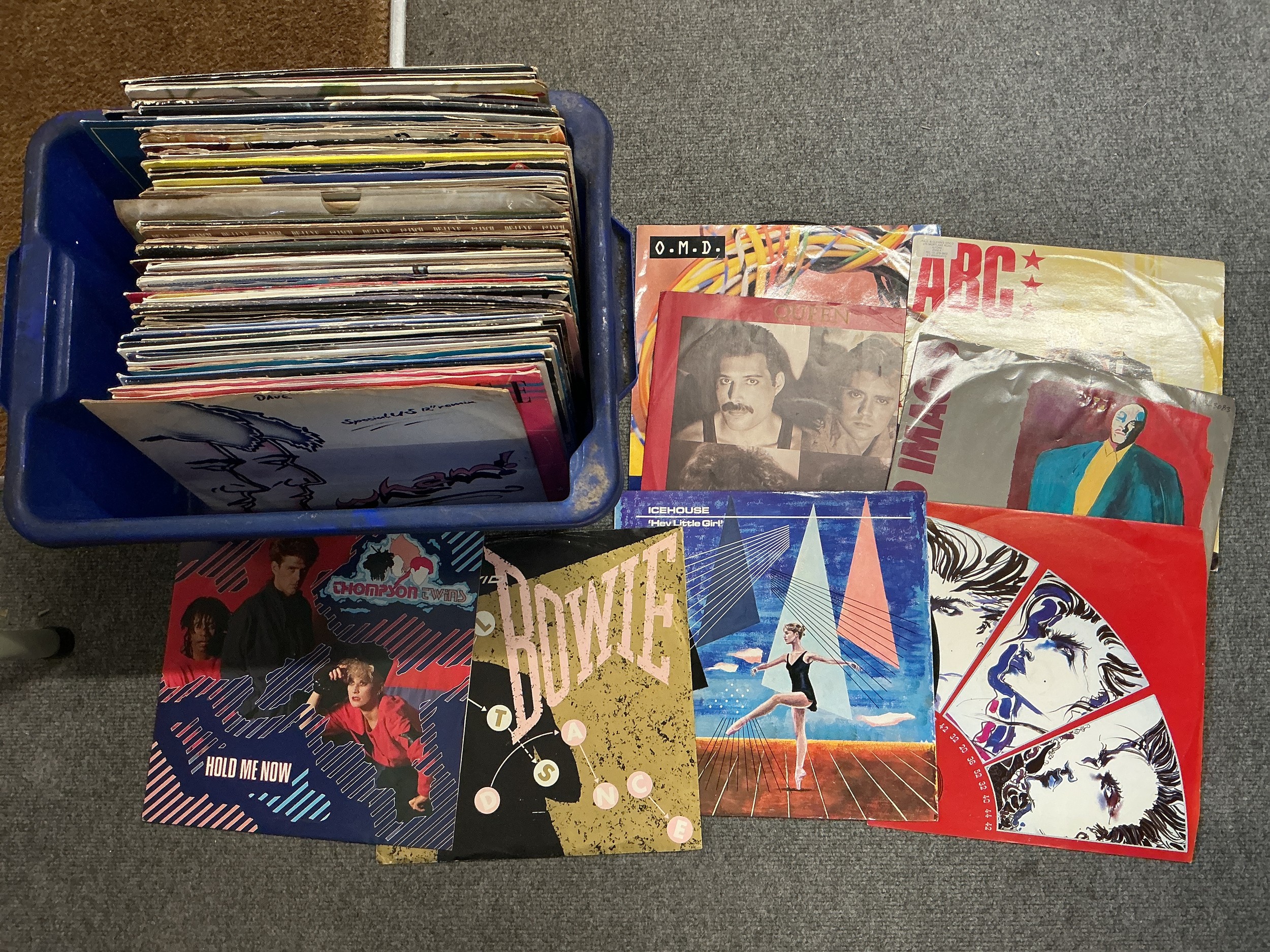 A box of 12" singles by various artists including David Bowie, Queen, Bruce Springsteen and many more.