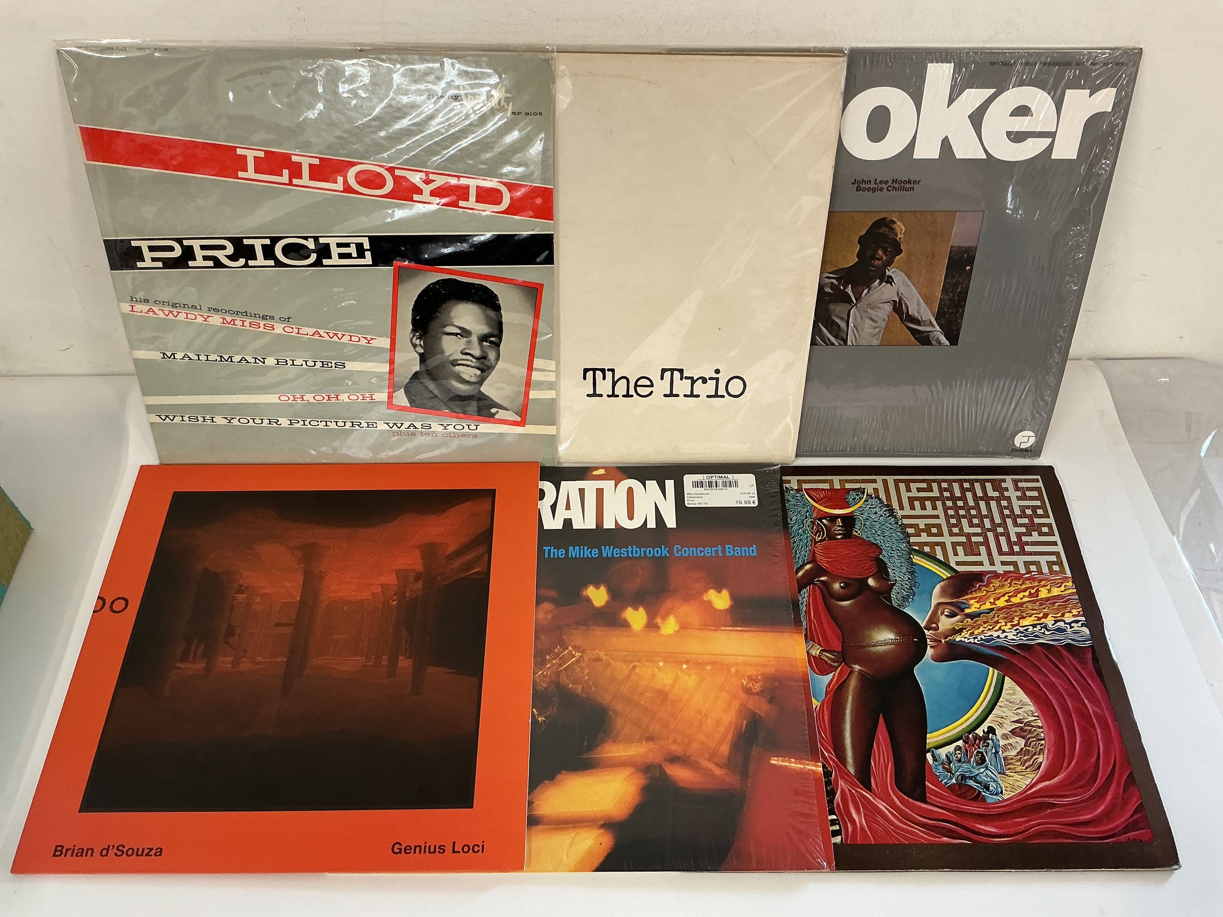 A record case of jazz and blues LPs by various artists including Miles Davis, John Lee Hooker, Lloyd Price and others.