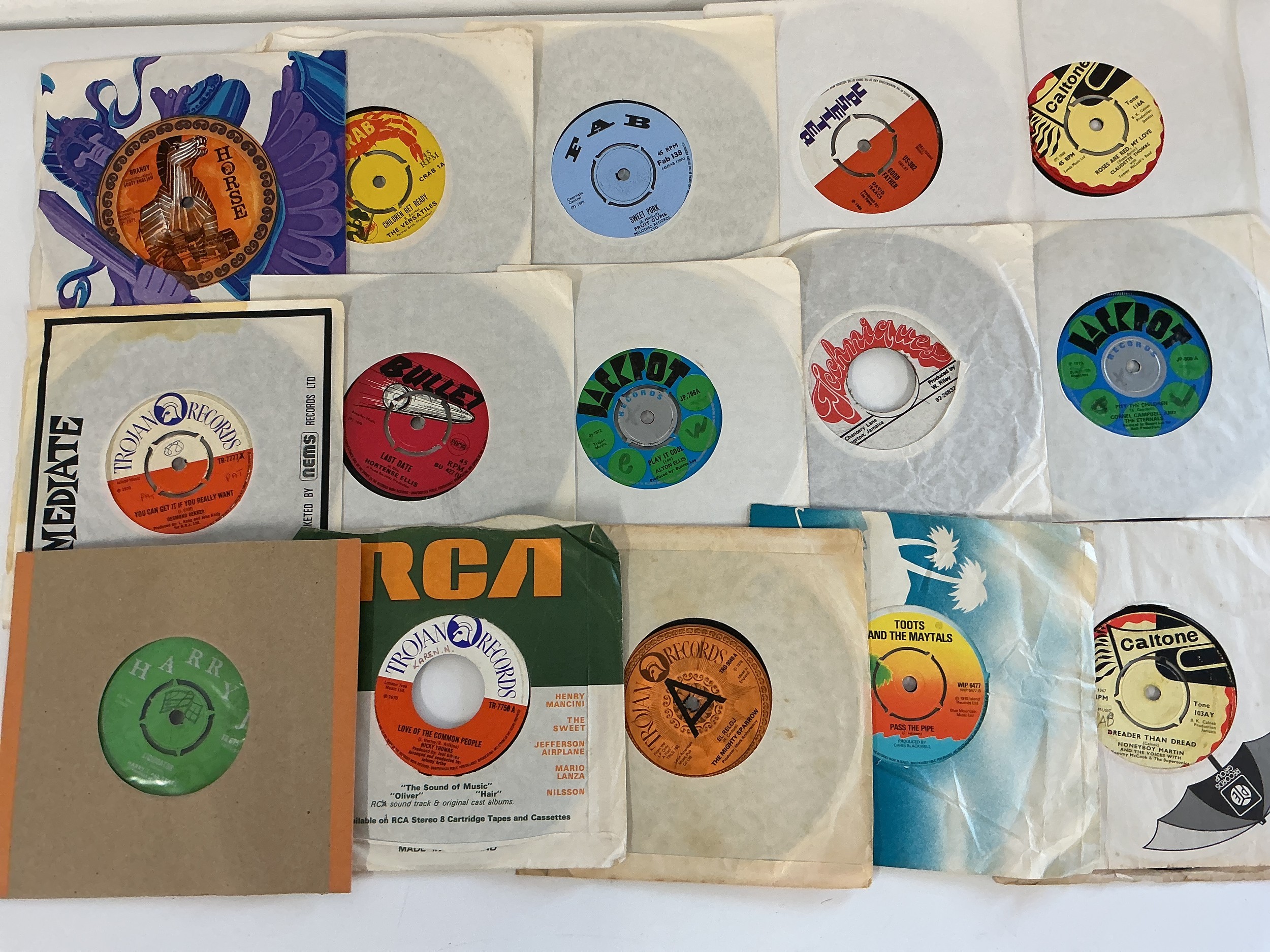 A collection of reggae 7" singles and soul promos by various artists including Desmond Dekker, Toots & The Maytals, Colonel Campbell and others.