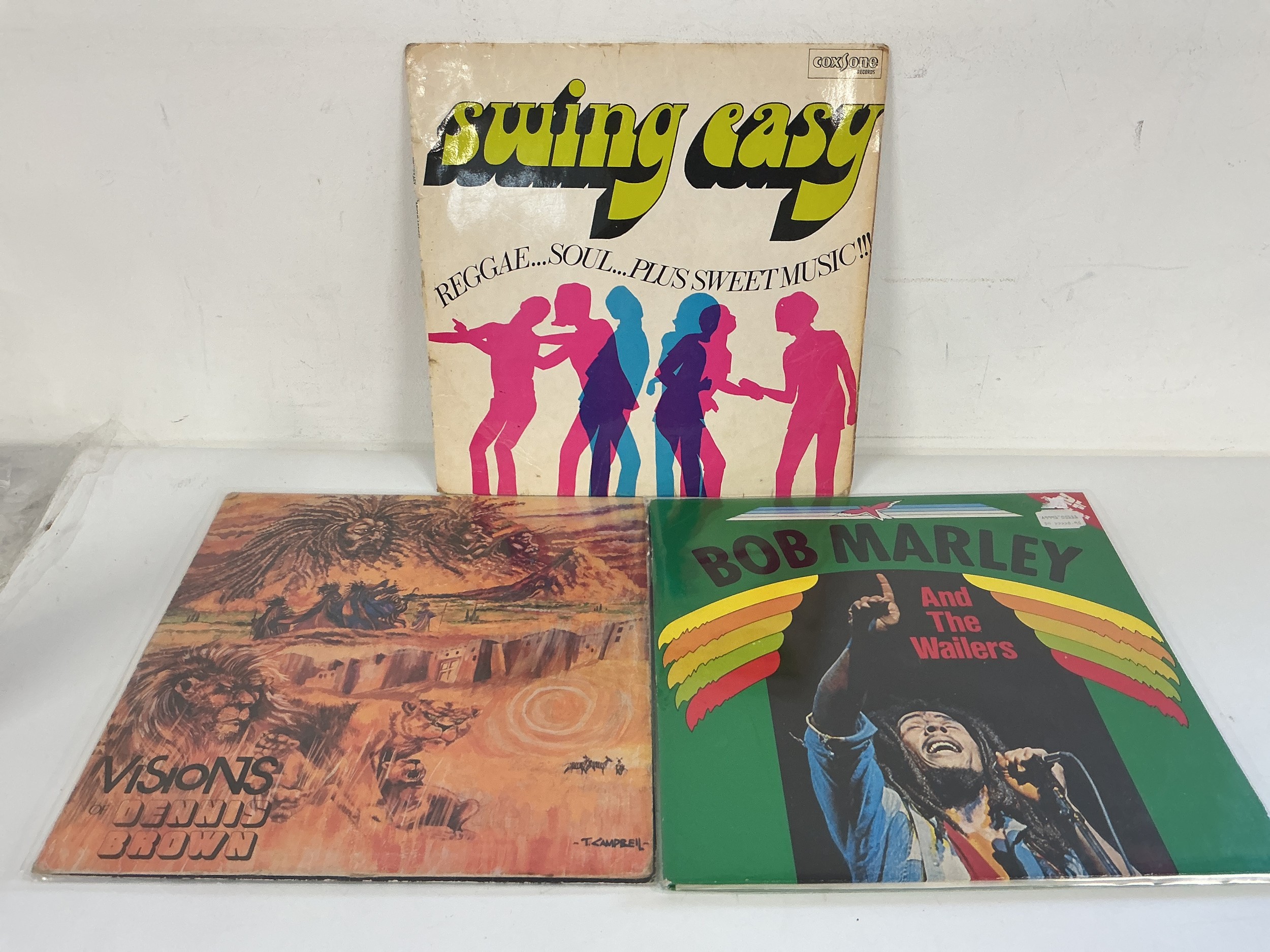 Three reggae LPs comprising a Swing Easy compilation on Coxsone Records plus LPs by Dennis Brown and Bob Marley.