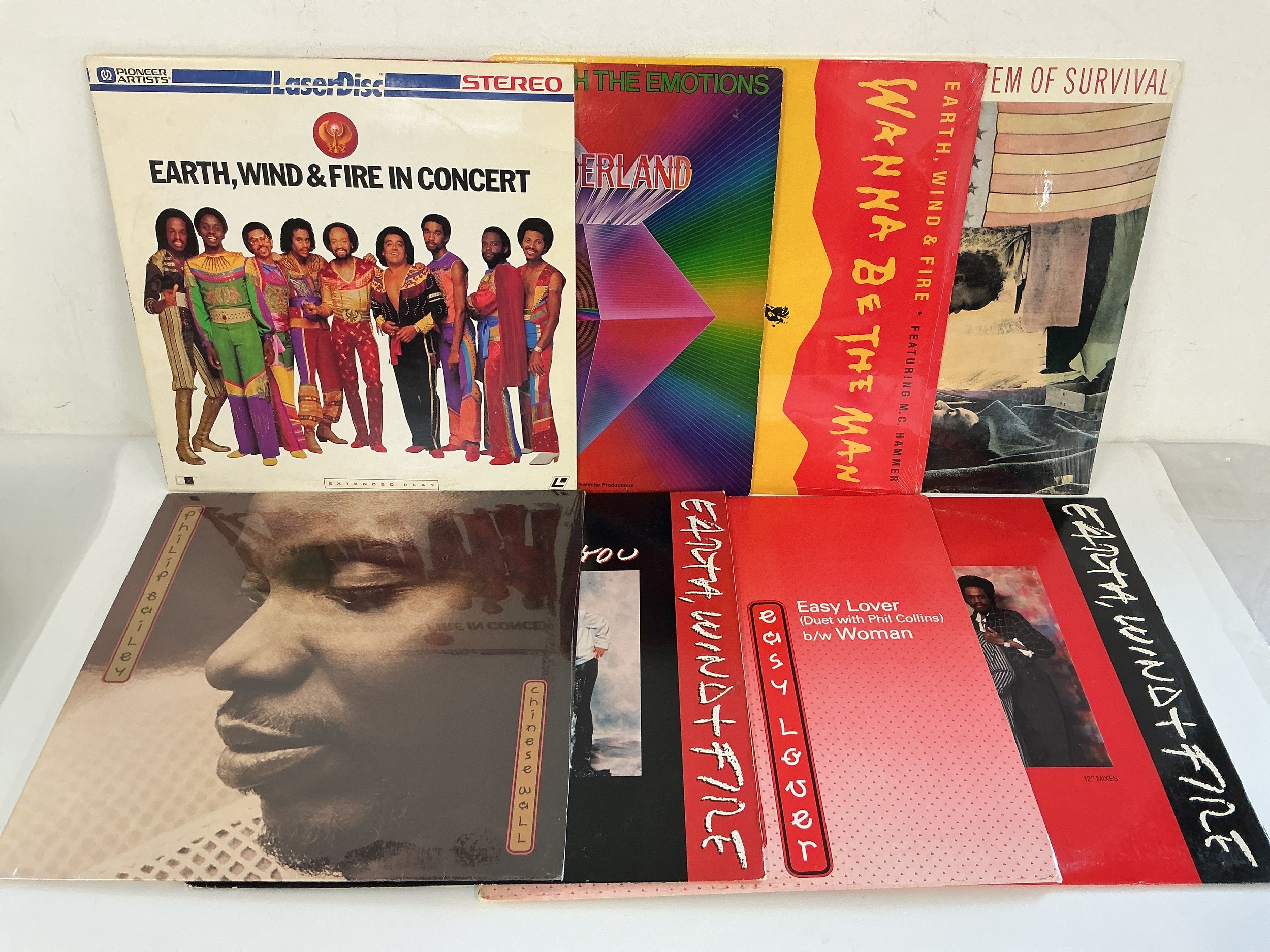 Two record cases of Earth, Wind & Fire and related 12" and 7" singles plus a laser disc. Includes demonstration discs.