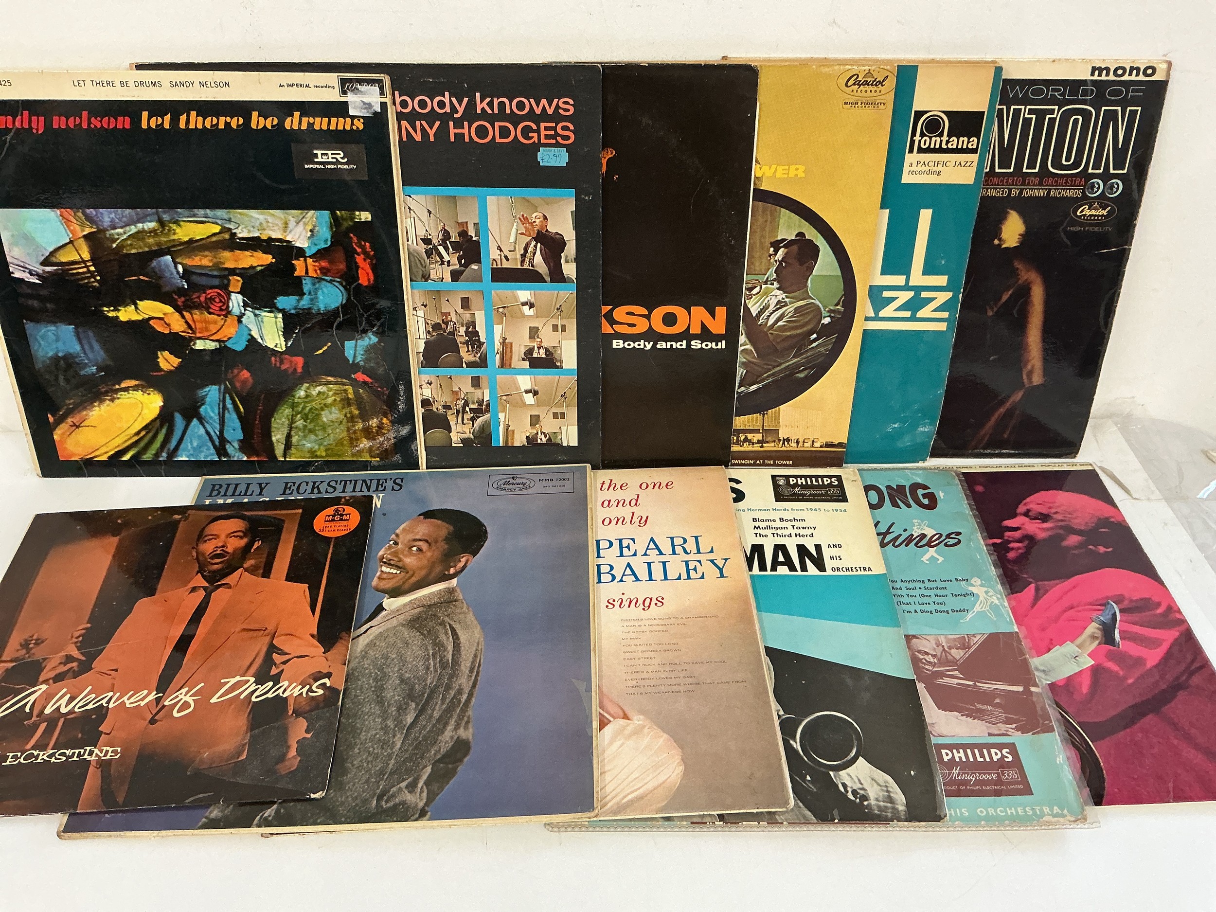 A collection of jazz LPs by various artists including Stan Kenton , Count Basie, Sidney Bechet and others.