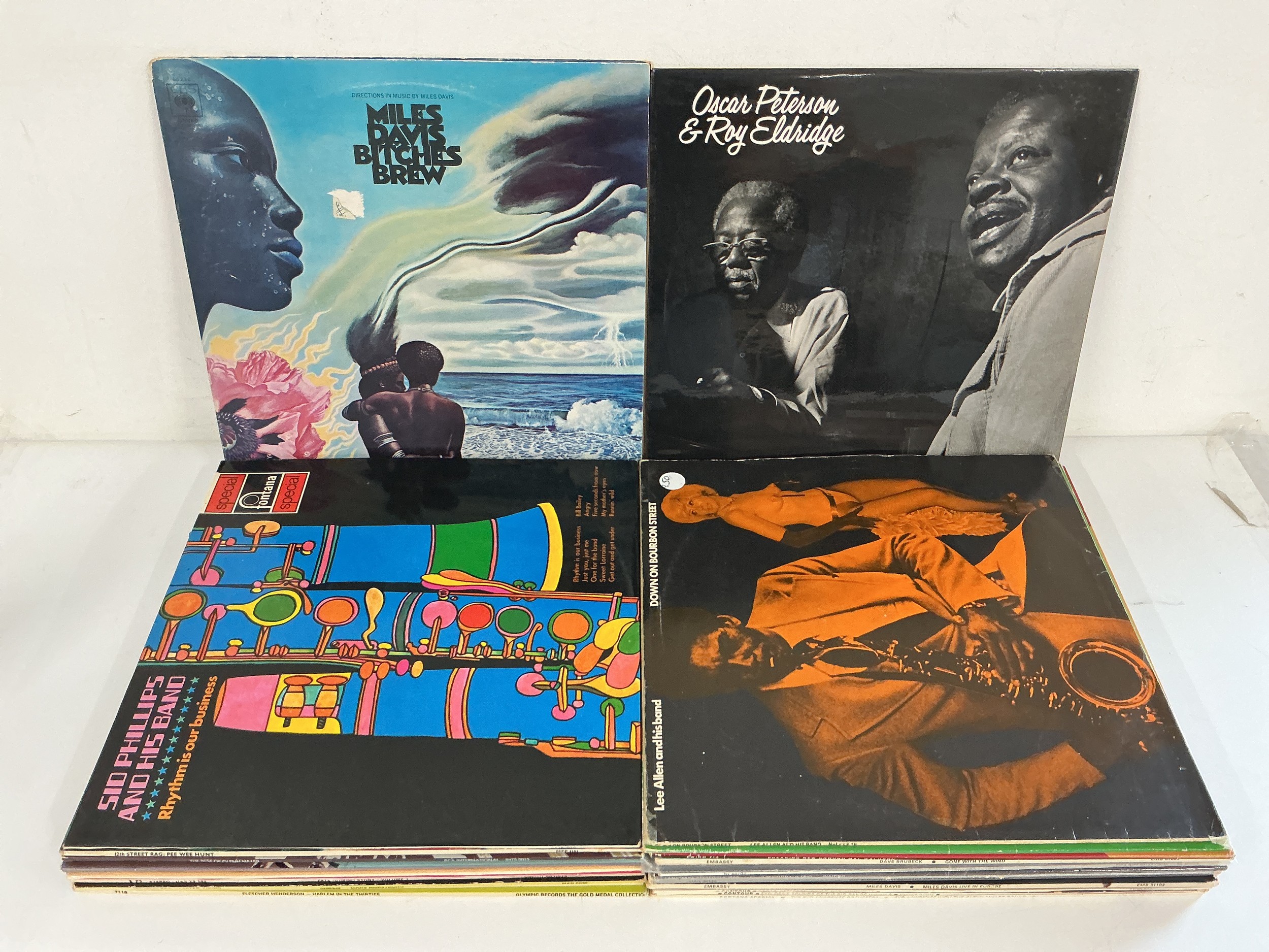 A collection of over 20 jazz LPs by various artists including Miles Davis, Oscar Peterson and others.