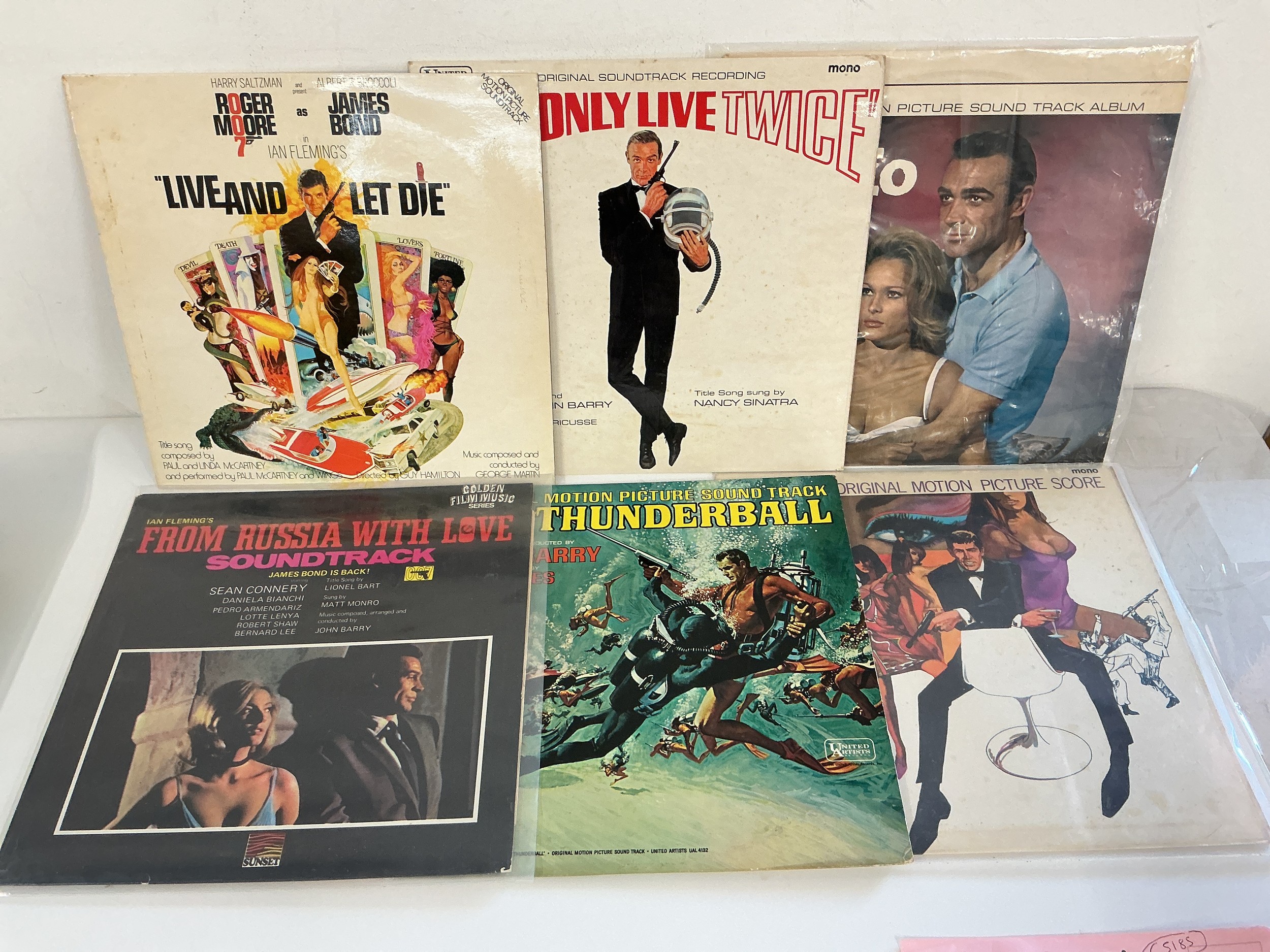 A record case of film soundtracks including various James Bond titles, Our Man Flint and others.