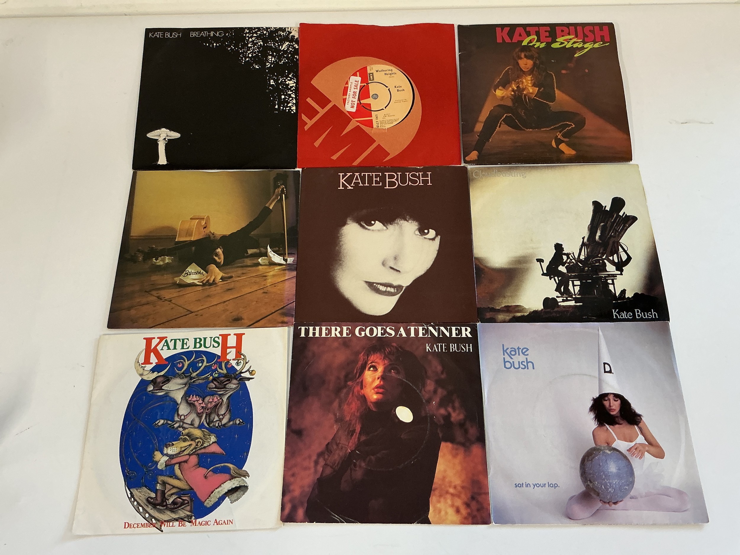 Nine Kate Bush 7" singles including a factory sample Wuthering Heights, demo discs of On Stage, Breathing, Wow and Babooshka etc.
