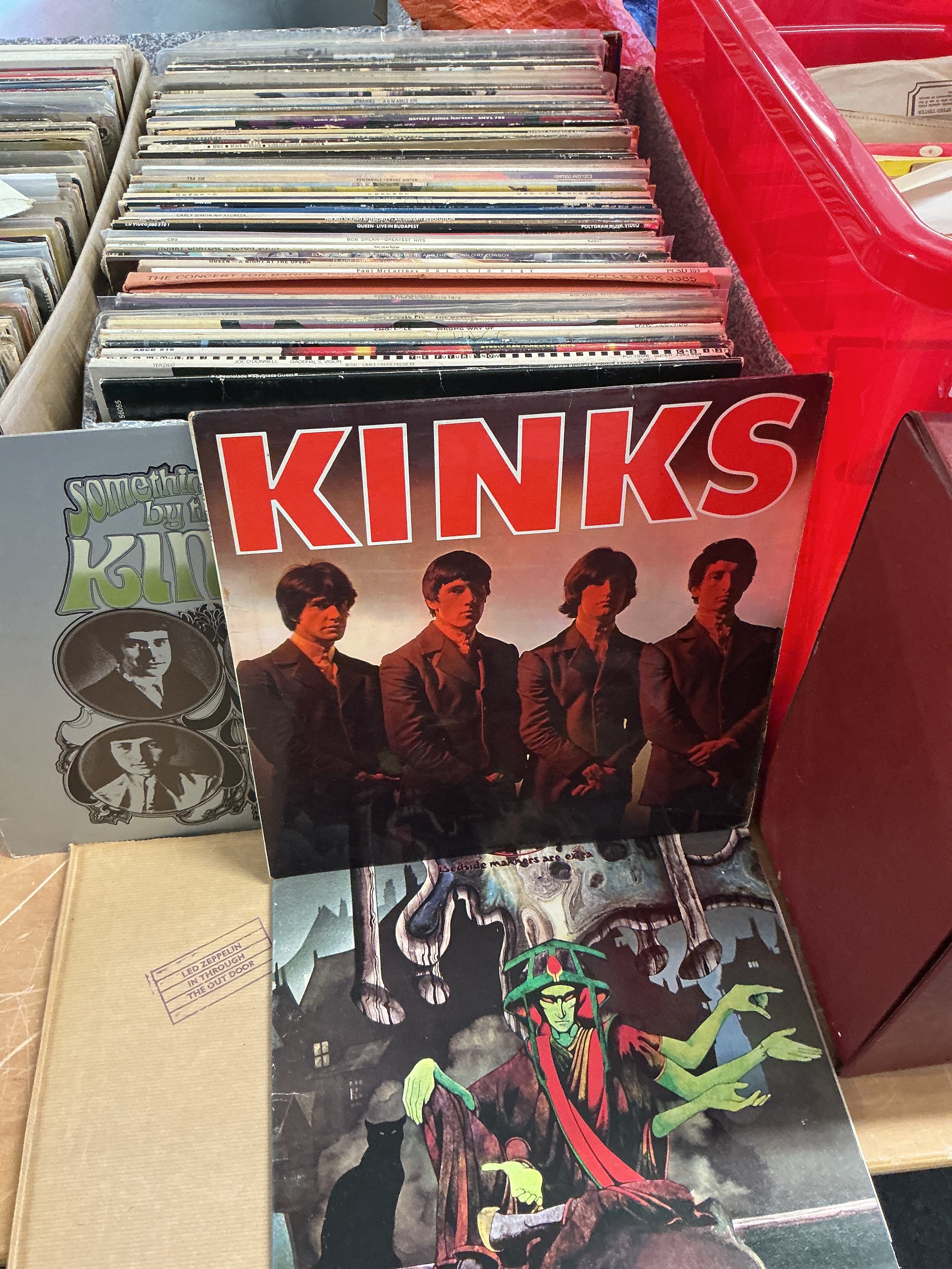 A box of LPs by various artists including Pink Floyd, The Beatles, Kinks, The Who, Led Zeppelin and many more. Includes misaligned Apple logo Abbey Road.