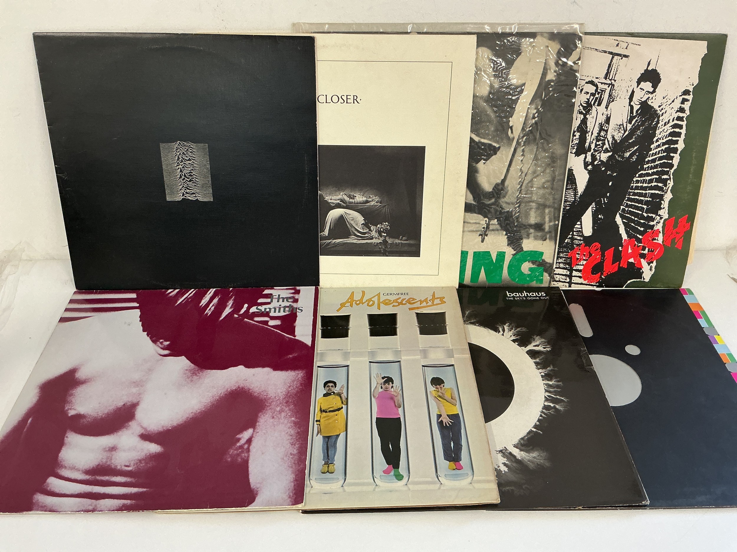 Sixteen punk and new wave LPs and 12" singles by various artists including Joy Division, The Clash, X Ray Spex, The Smiths and others.