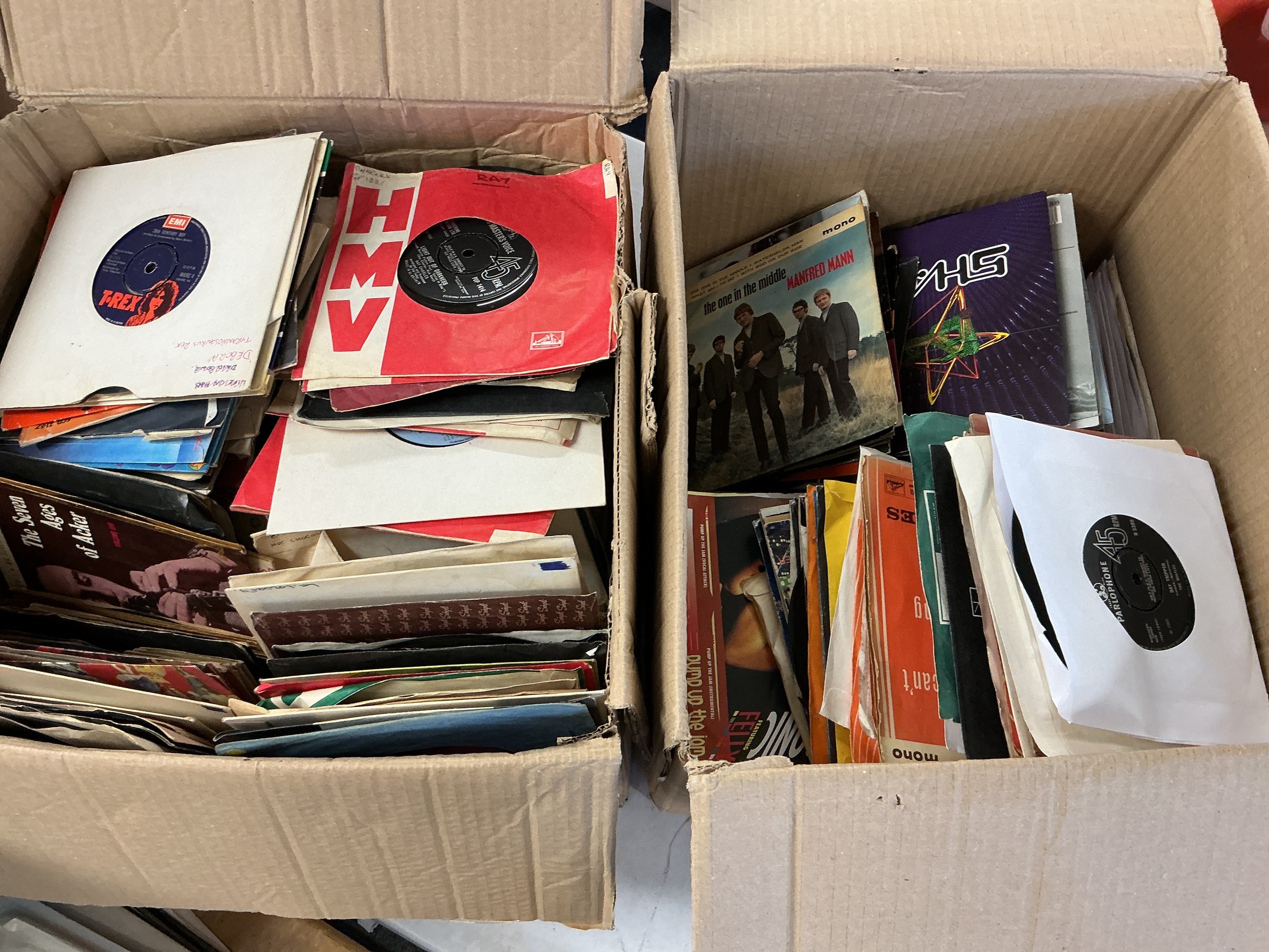 Two boxes of 7" singles and EPs by various artists including The Beatles, T Rex, Bruce Springsteen and many more.