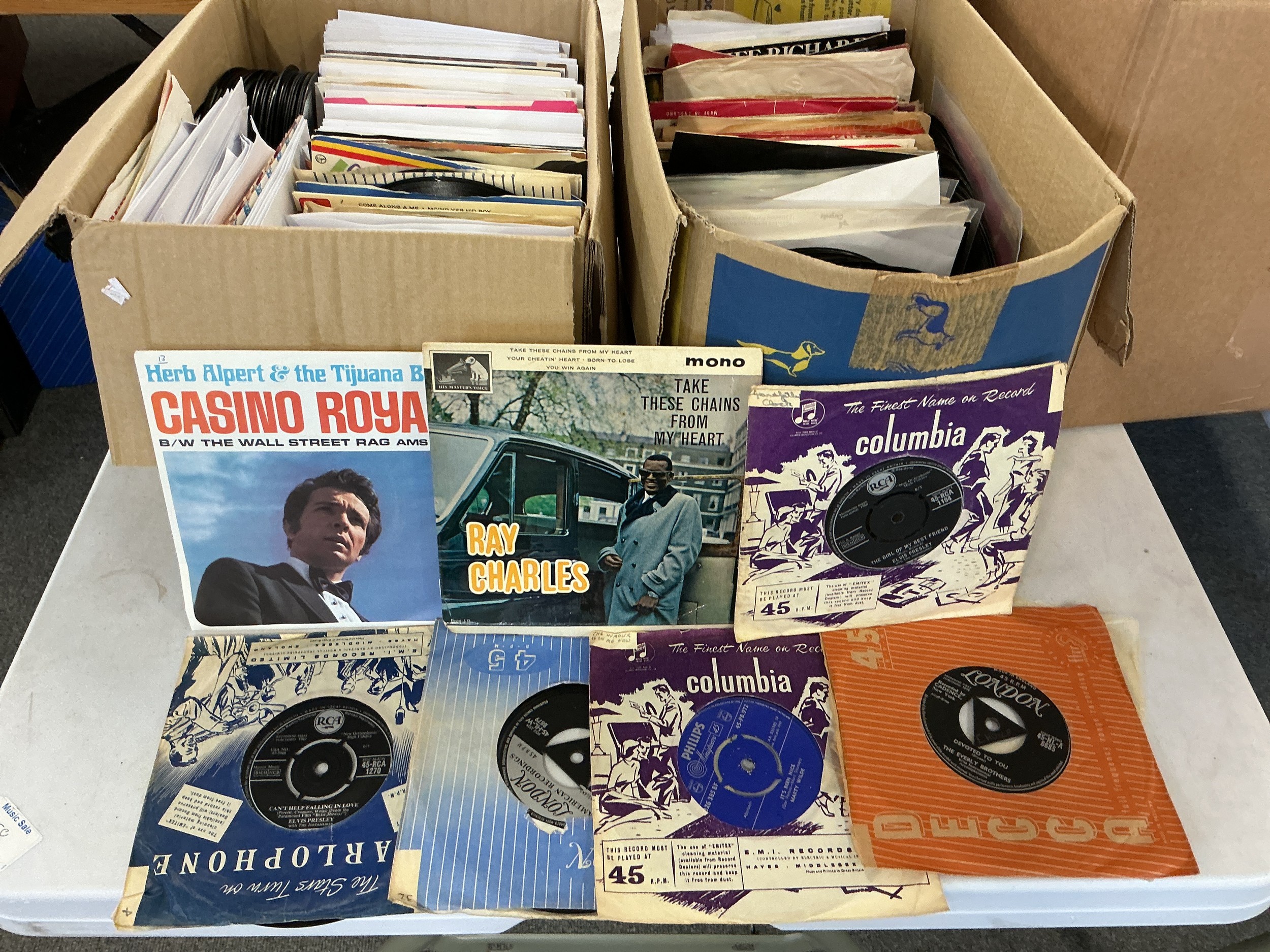 Four boxes of 7" singles by various artists from the 1950s onwards.