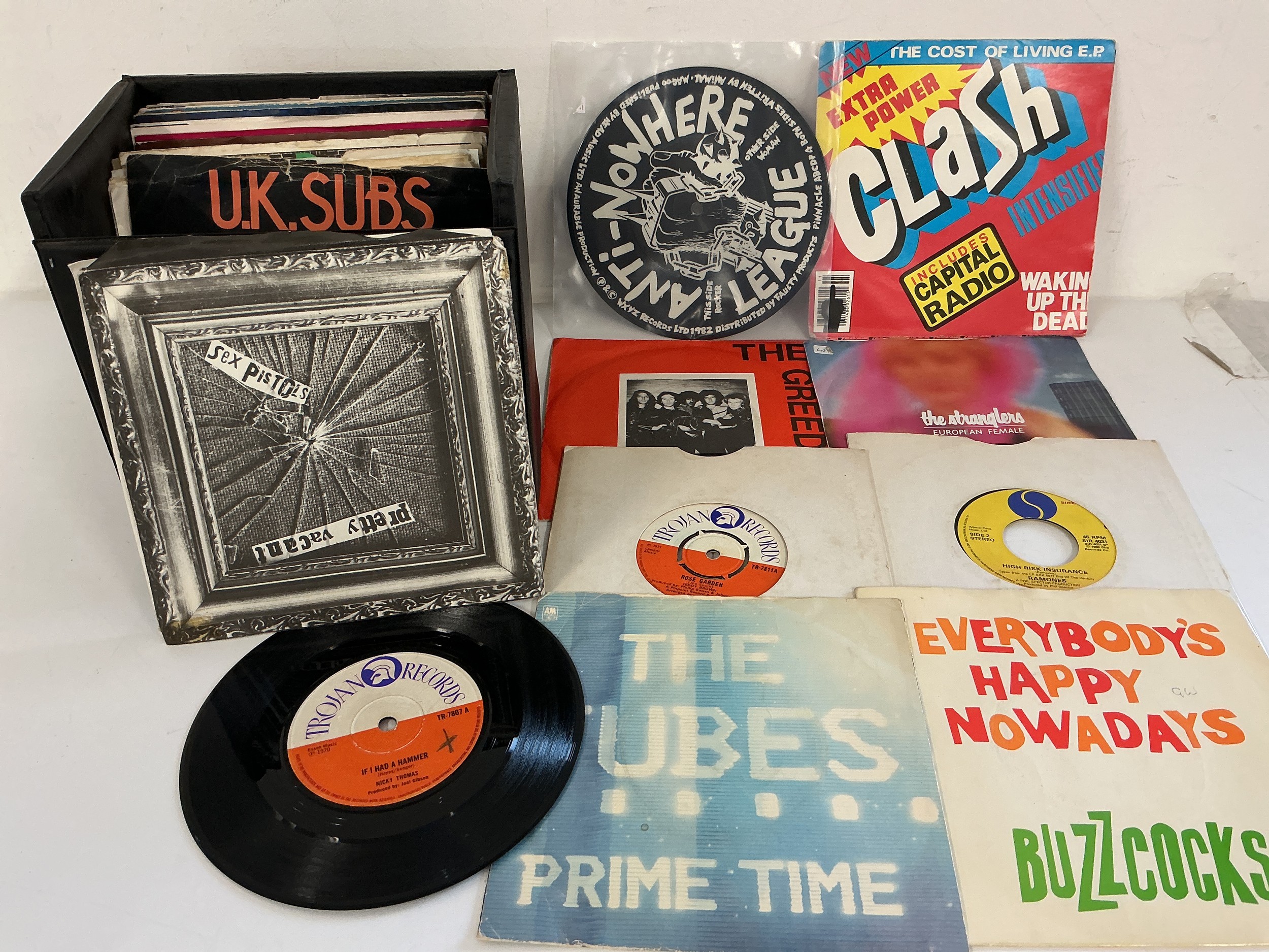 A record case of reggae, punk and indie 7" singles by various artists including Sex Pistols, The Clash, Lightning Seeds and others.