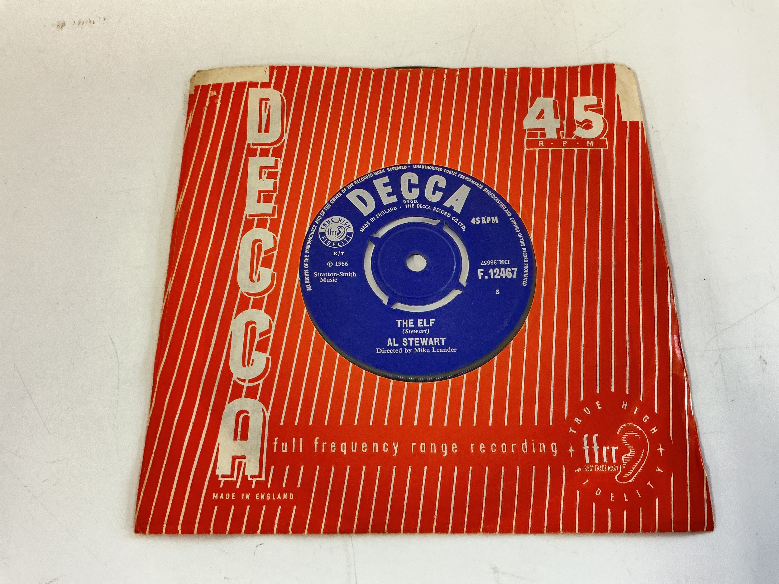 A scarce first pressing of the Al Stewart debut 7" single The Elf b/w Turn Into Earth on the Decca label F.12467. Released in 1966 the recording features an uncredited Jimmy Page on guitar. Vinyl EX.