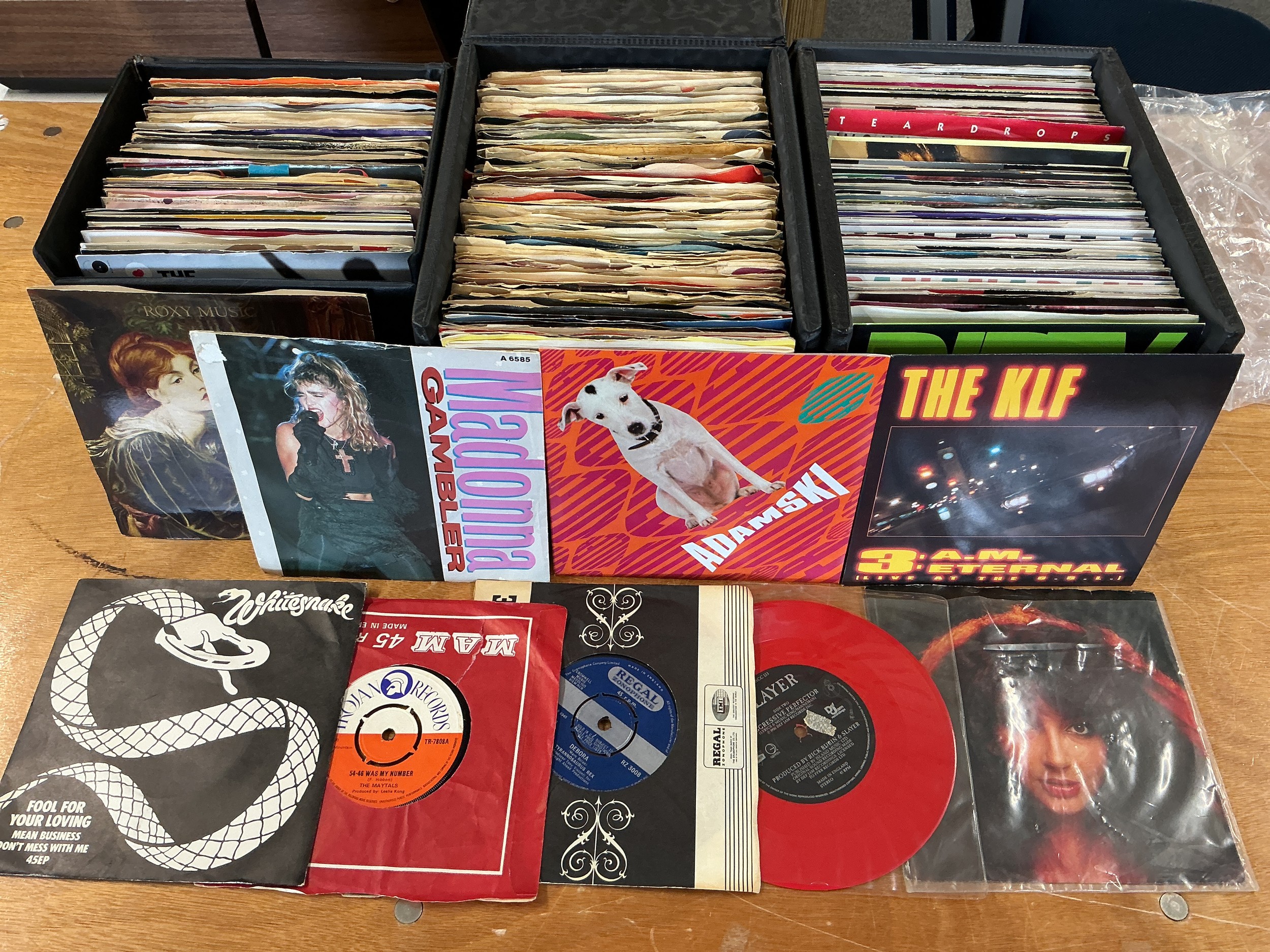 A collection of 7" singles and LPs in three records cases and a box by various artists including Tyrannosaurus Rex, Kate Bush, various Motown artists and many more.