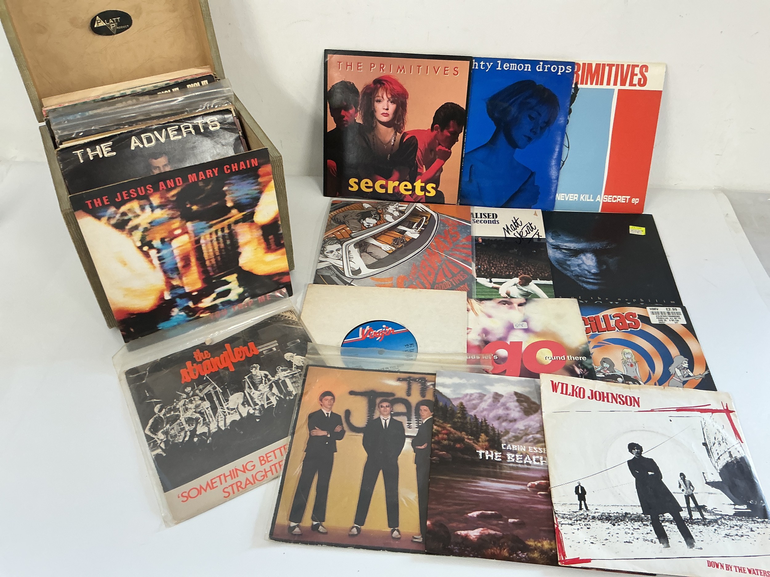 A record case of 7" singles and EPs by various artists including The Jam, Jesus & Mary Chain, Sex Pistols and others.