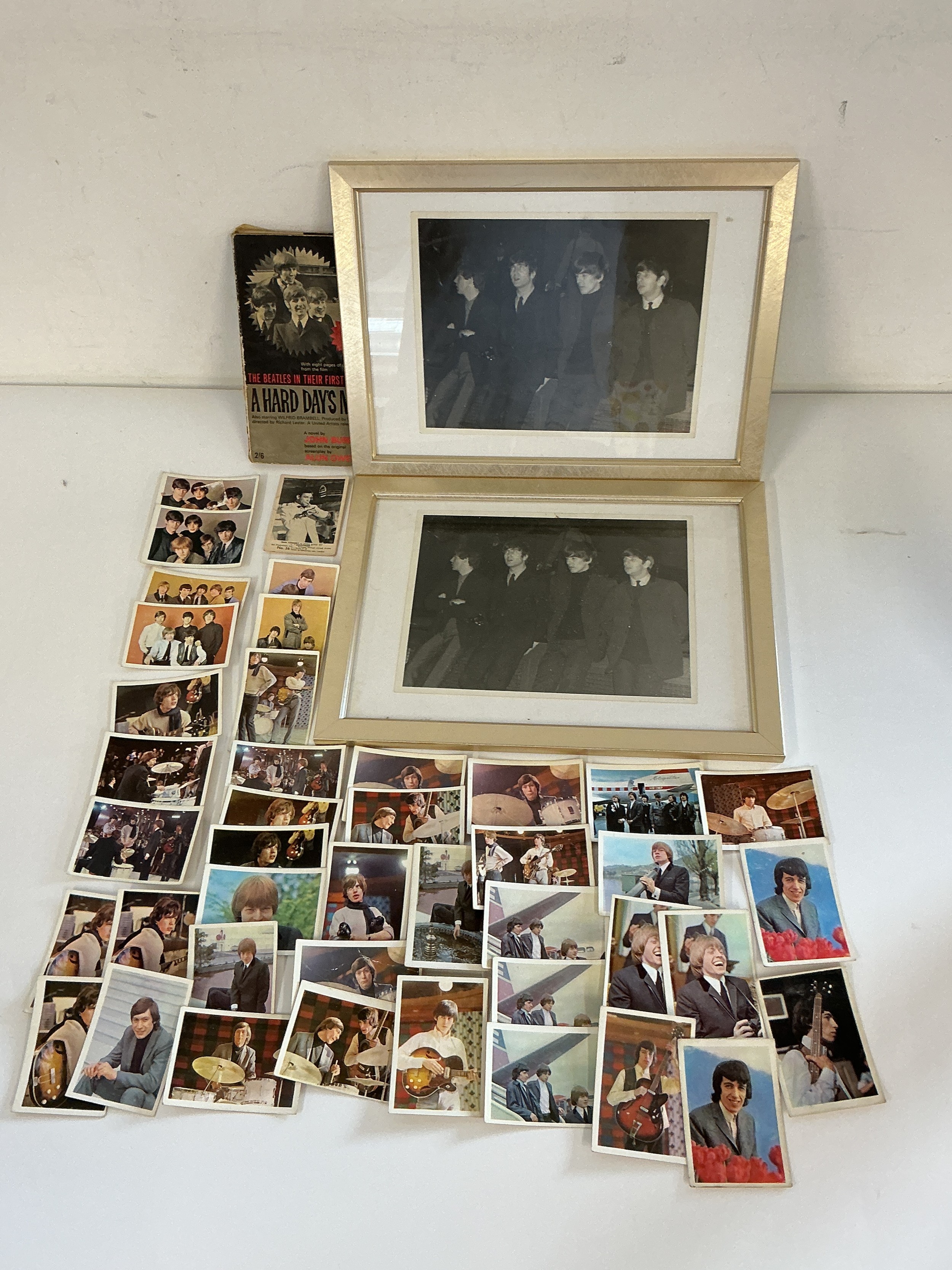 A collection of Beatles and Rolling Stones ephemera comprising two original black and white photographs taken whilst The Beatles were appearing at the Southend Odeon, Beatles and Rolling Stones A+BC cards and a Hard Day's Night paperback book.