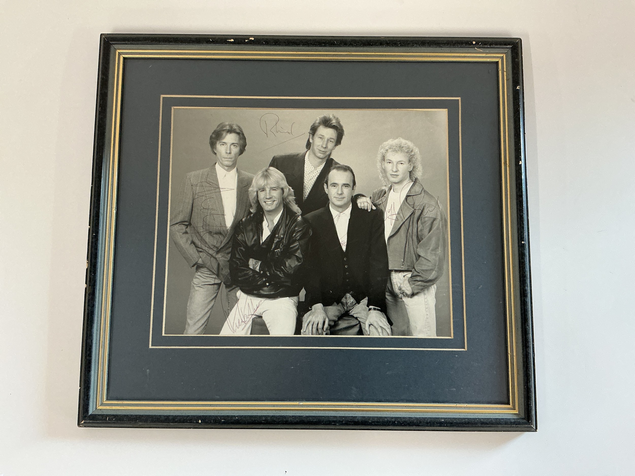 A framed and glazed fully signed Status Quo publicity photo. No COA.