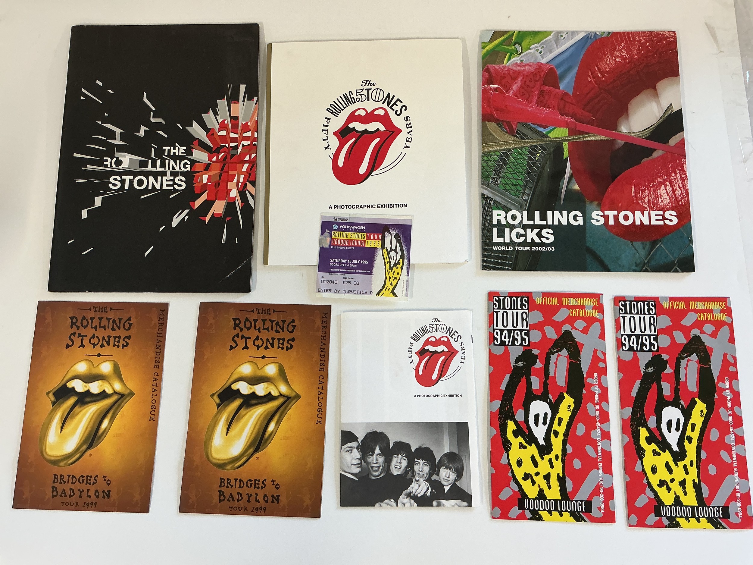A collection of Rolling Stones memorabilia comprising tour brochures, tickets, plate signed posters (printed signatures), books etc.