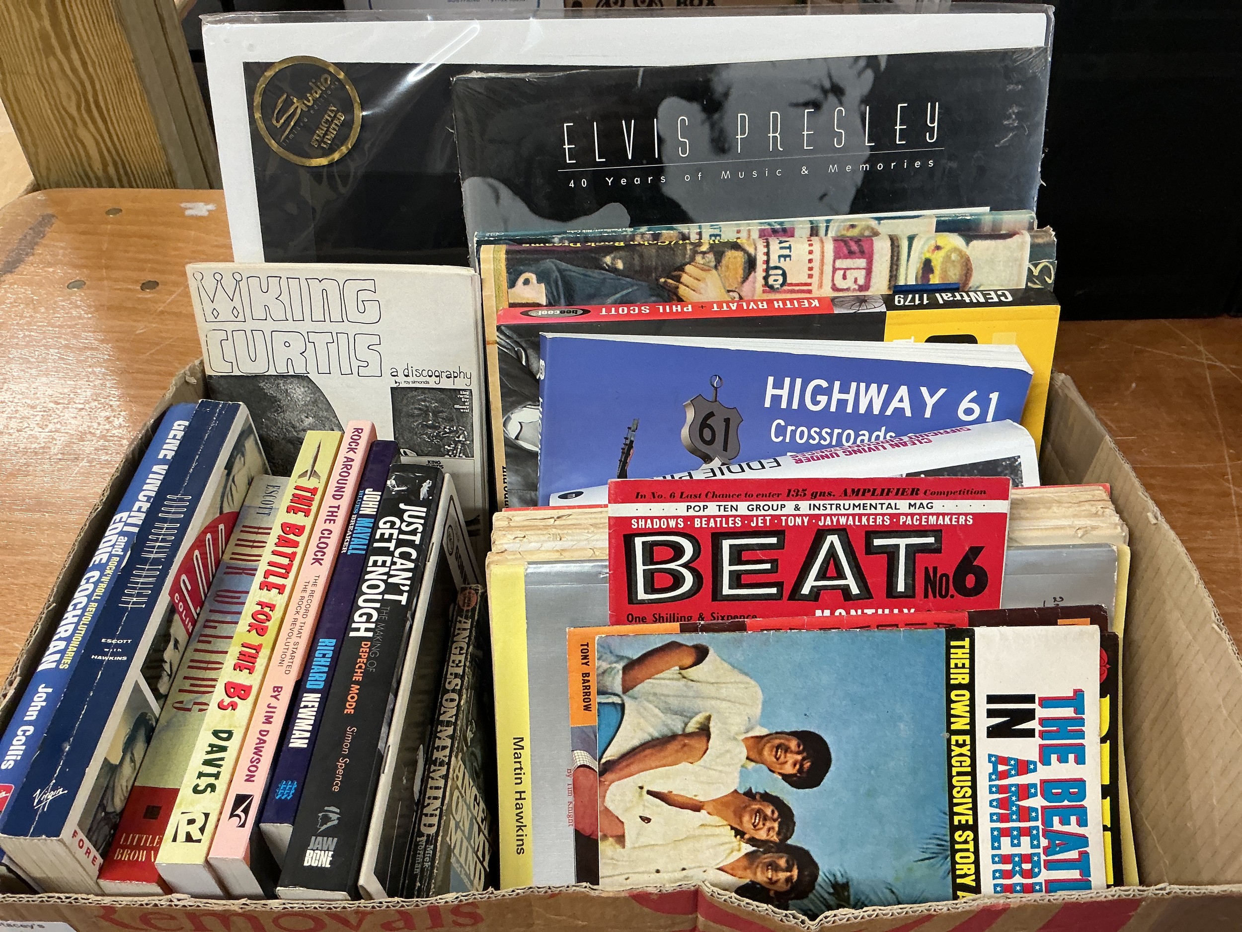 A box of music books and magazines.