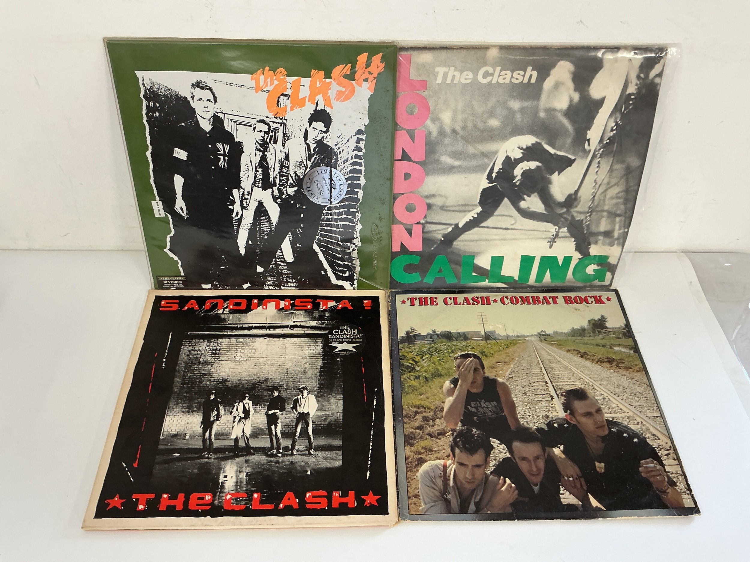 Four LPs by The Clash comprising London Calling, the self titled debut, Sandinista and Combat Rock.