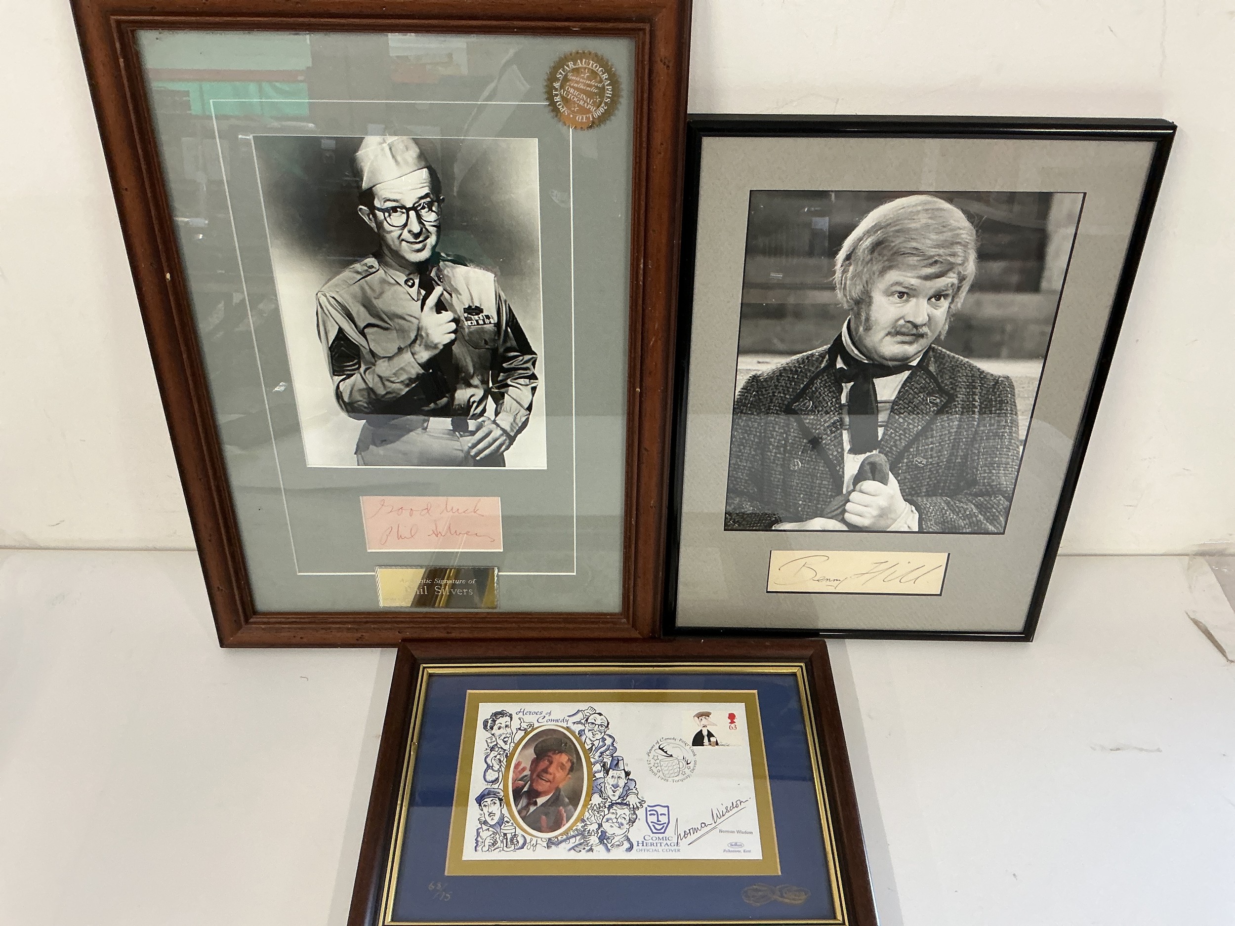 Three framed autographs comprising Benny Hill, Phil Silvers and Norman Wisdom.