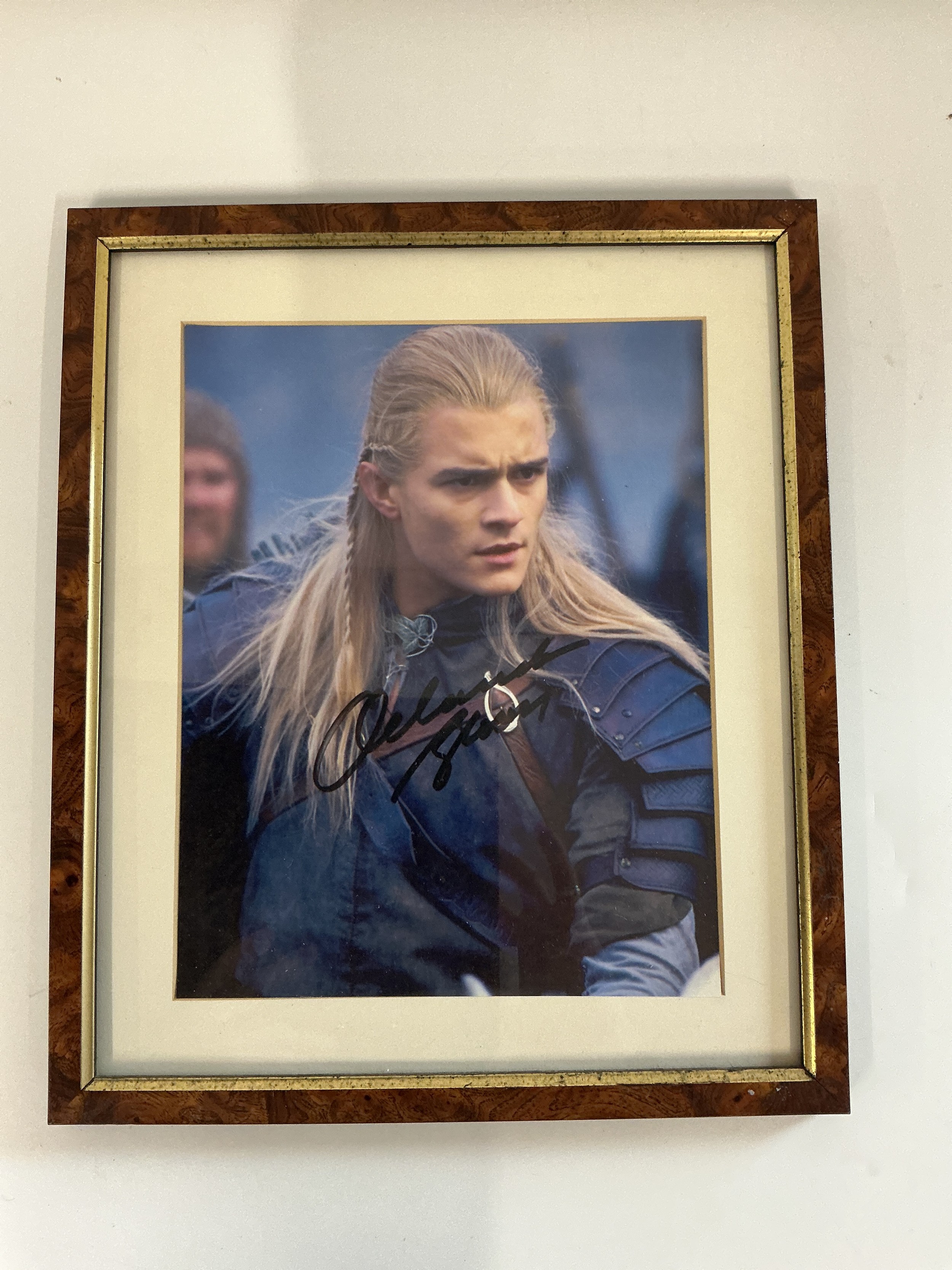 A framed glazed signed photo of Orlando Bloom.