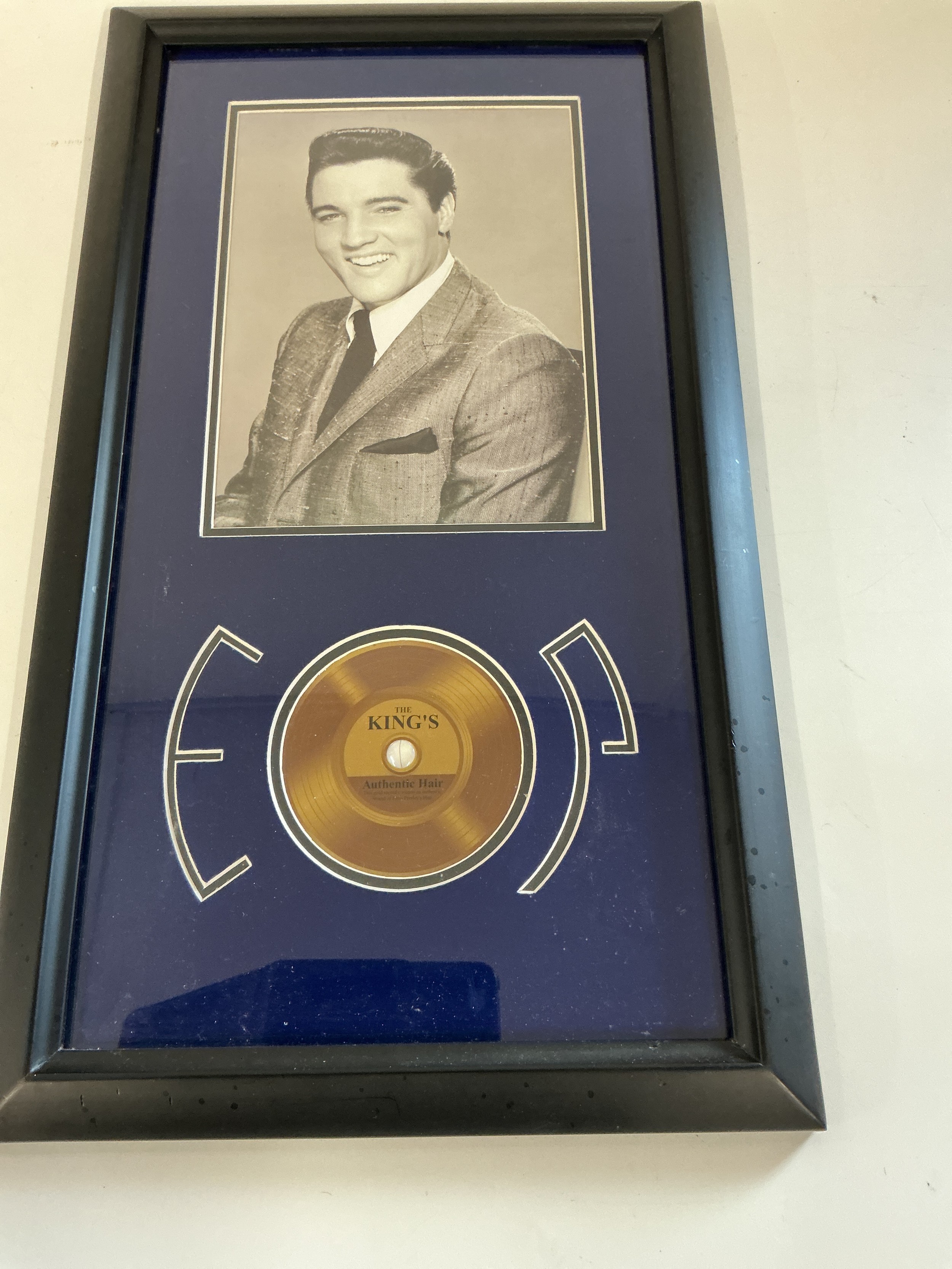 A framed and glazed Elvis Presley presentation containing a strand of authentic hair. Comes with COA.