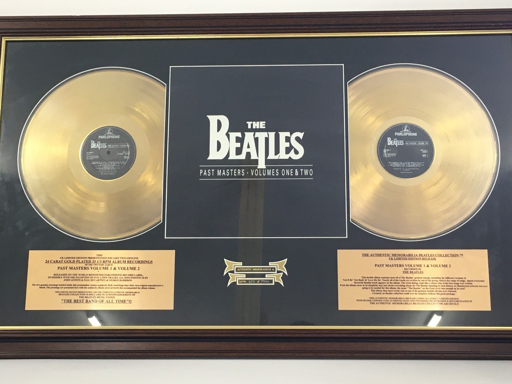 A framed and glazed limited edition Beatles double gold disc display for the Past Masters album, numbered 626/5000, approx 99cm x 60cm.