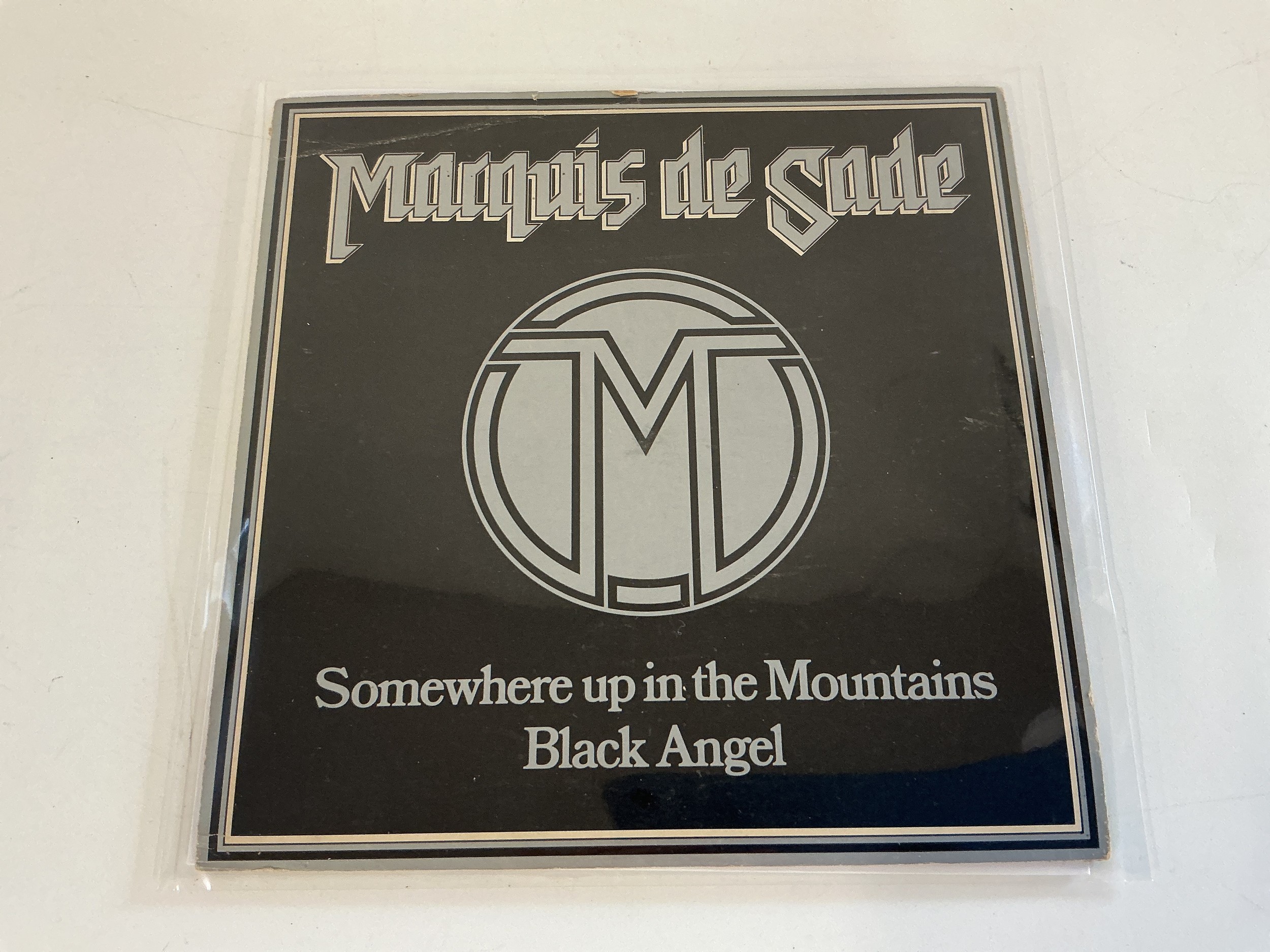 A rare 1981 NWOBHM 7" single by Marquis De Sade - Somewhere Up In The Mountains b/w Black Angel. Complete with insert. The single was self released and was only a tiny print run. NM.