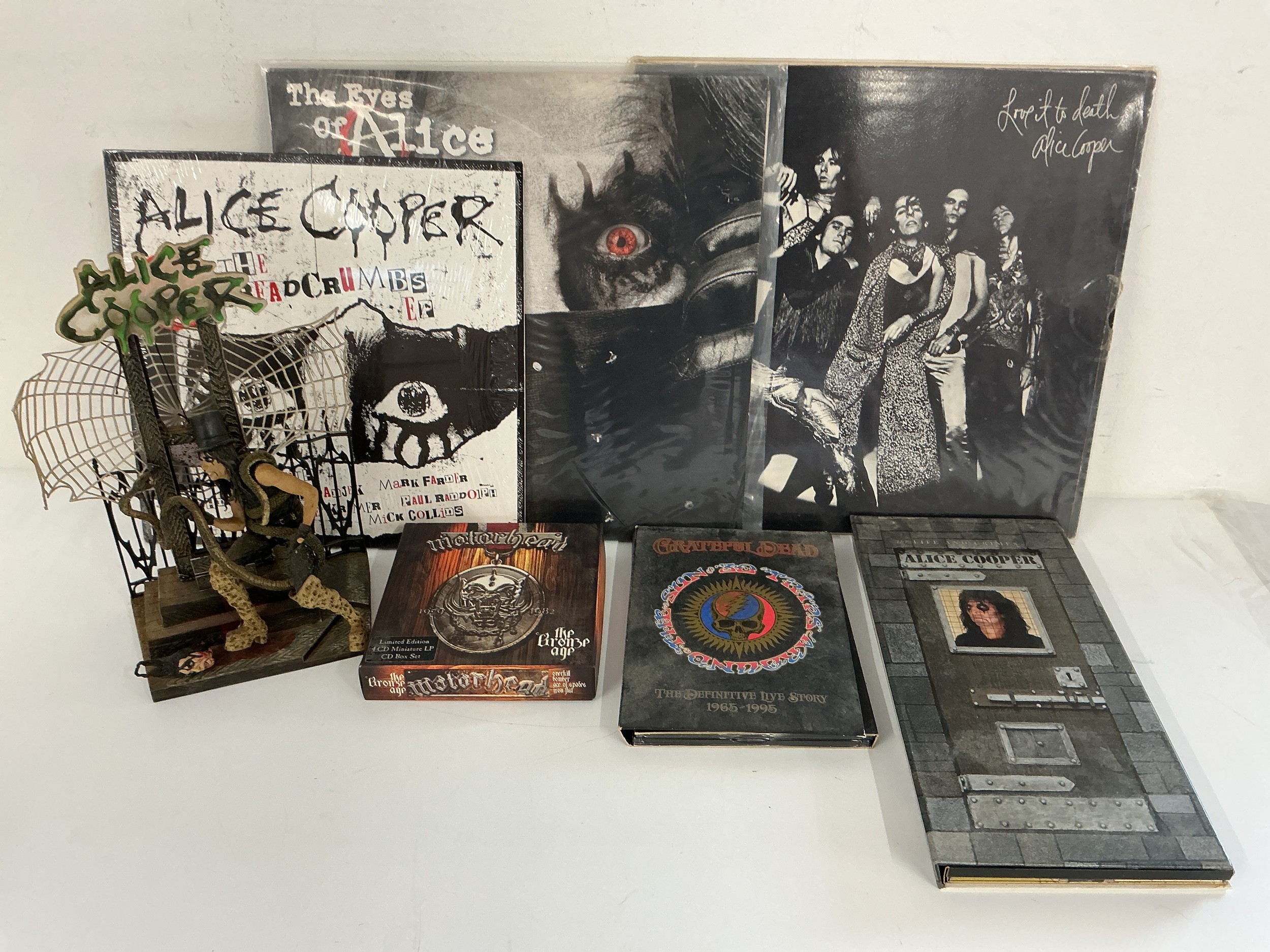 Two Alice Cooper LPs and a 10" EP plus a CD long box and Alice diorama plus two CD box sets by Motörhead (missing two discs) and The Grateful Dead.