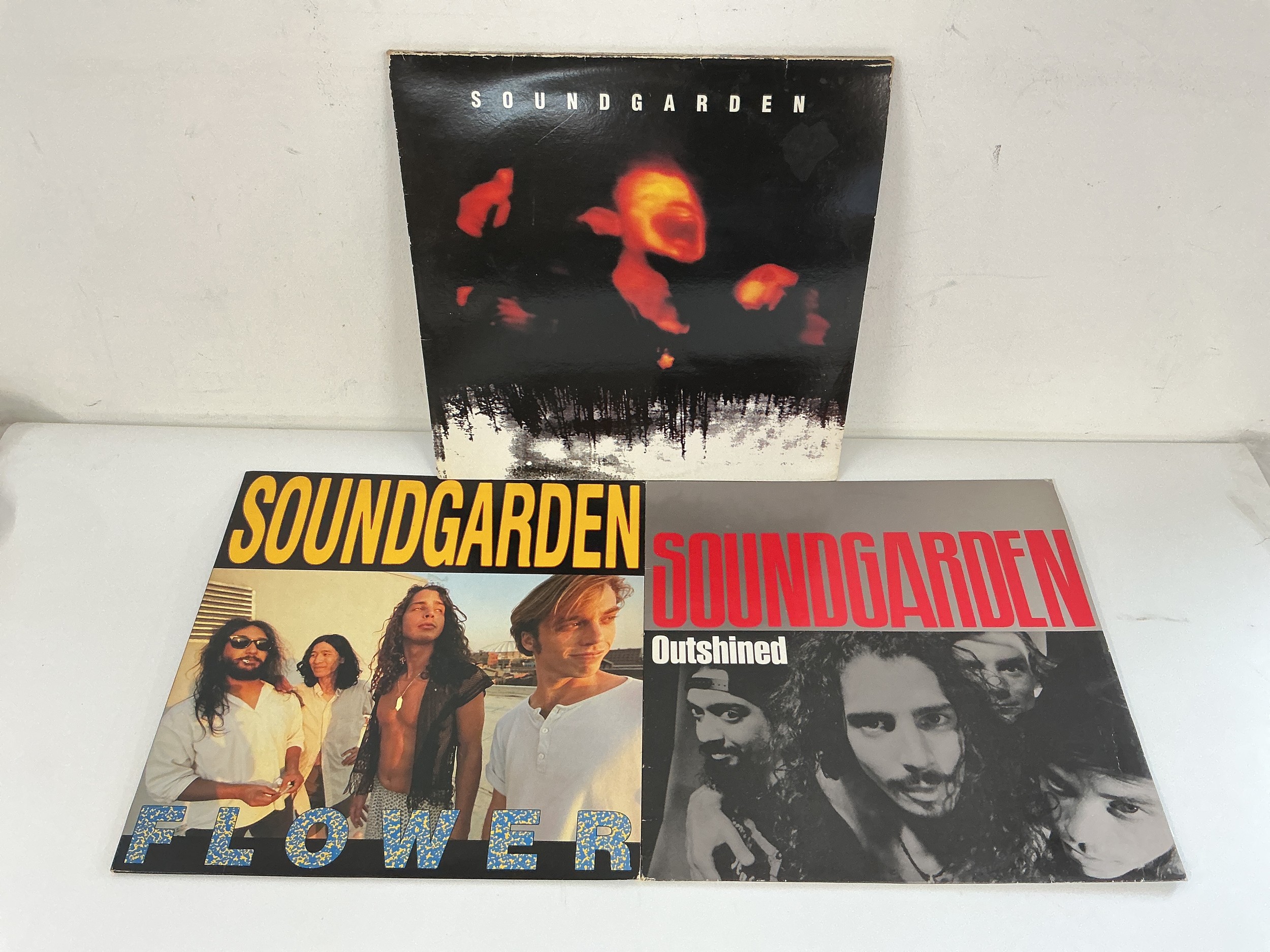 A 1994 limited edition Soundgarden 'Superunknown' 2LP on clear vinyl plus a Flower EP and an Outshined 12" single. All vinyl EX and complete with inserts.