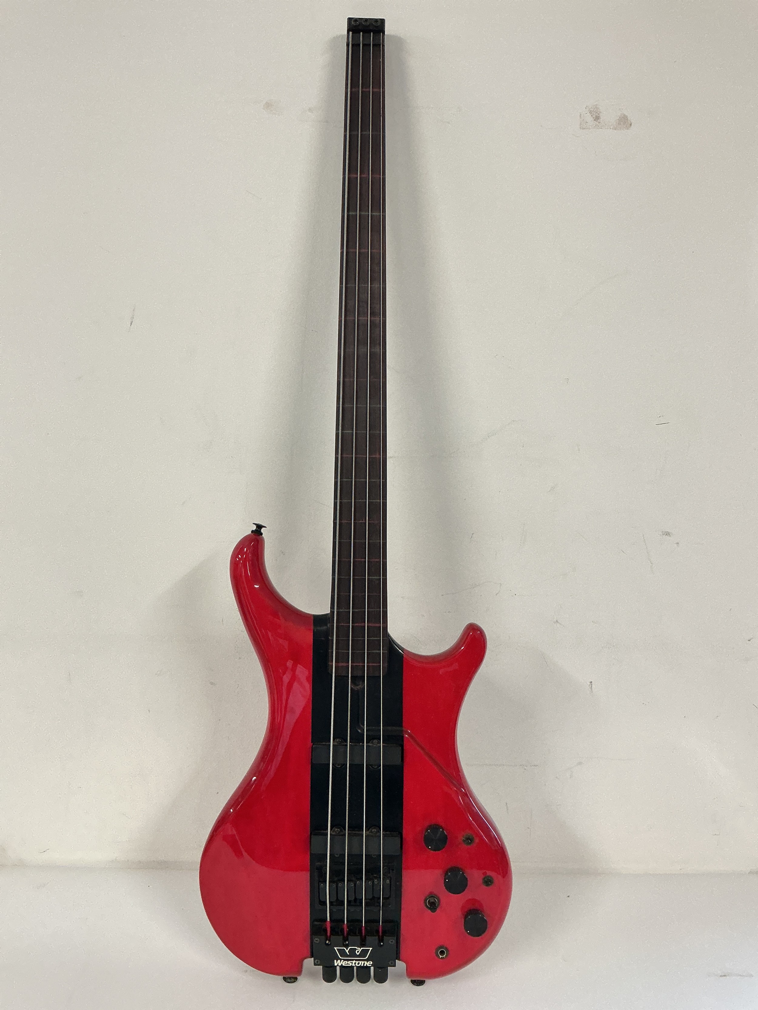 A Westone fretless and headless super bass guitar. Comes with a hard carry case.