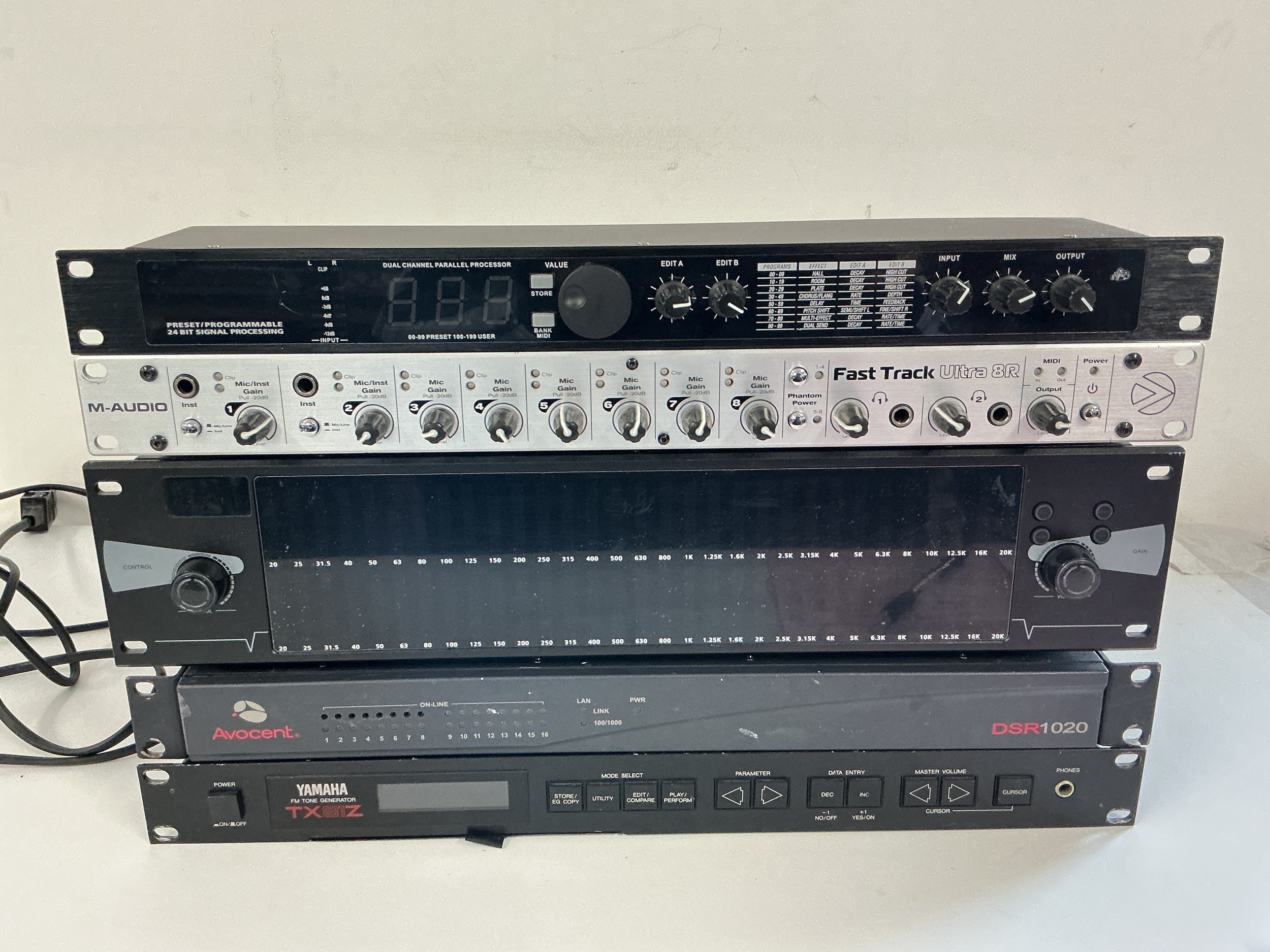 Five rack effects units comprising a Yamaha TX81Z FM tone generator, an M-Audio Fast Track Ultra 8R and other items.